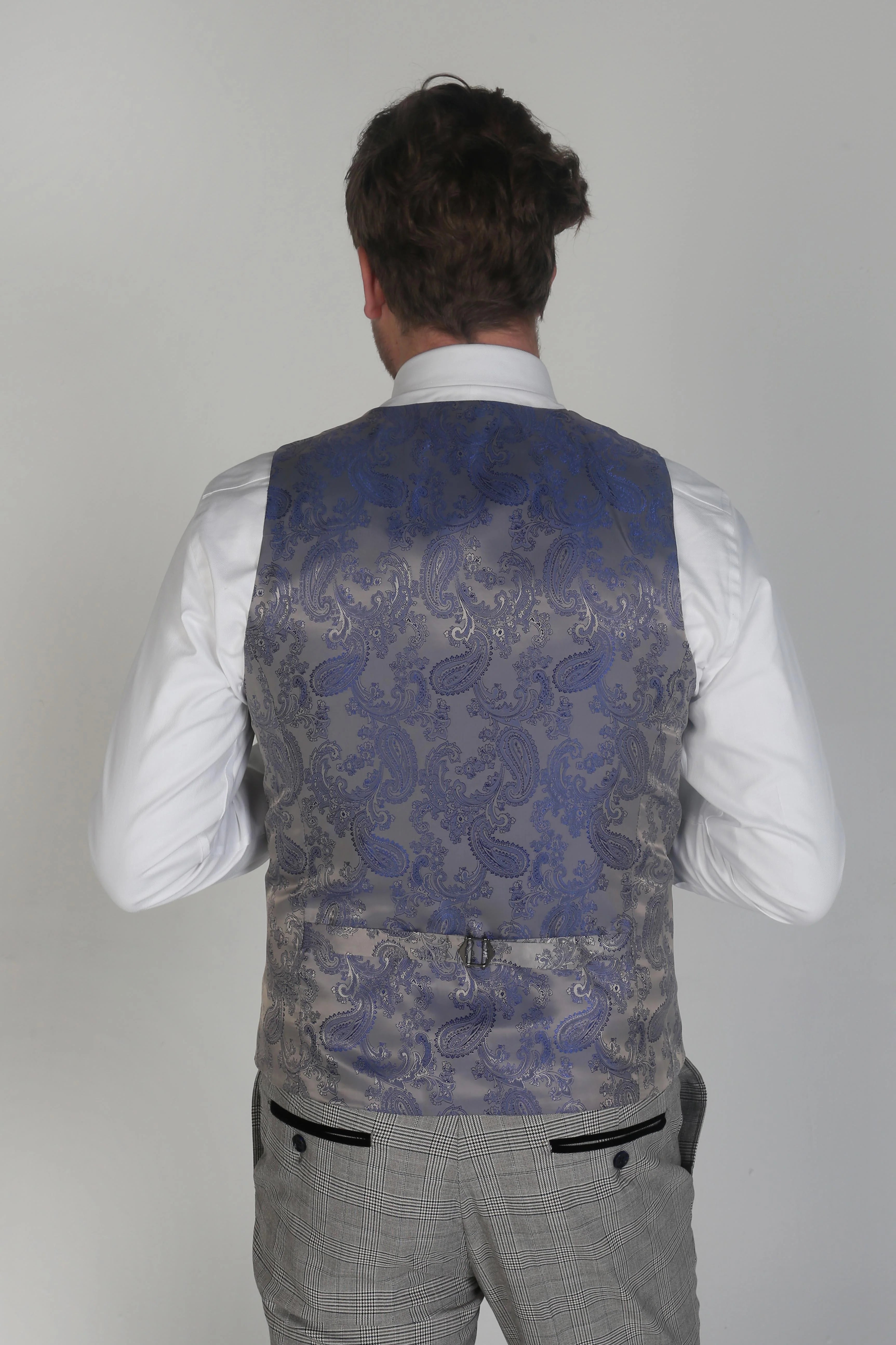 Back view of a man wearing a Hugo grey checkered waistcoat with an intricate blue paisley pattern.