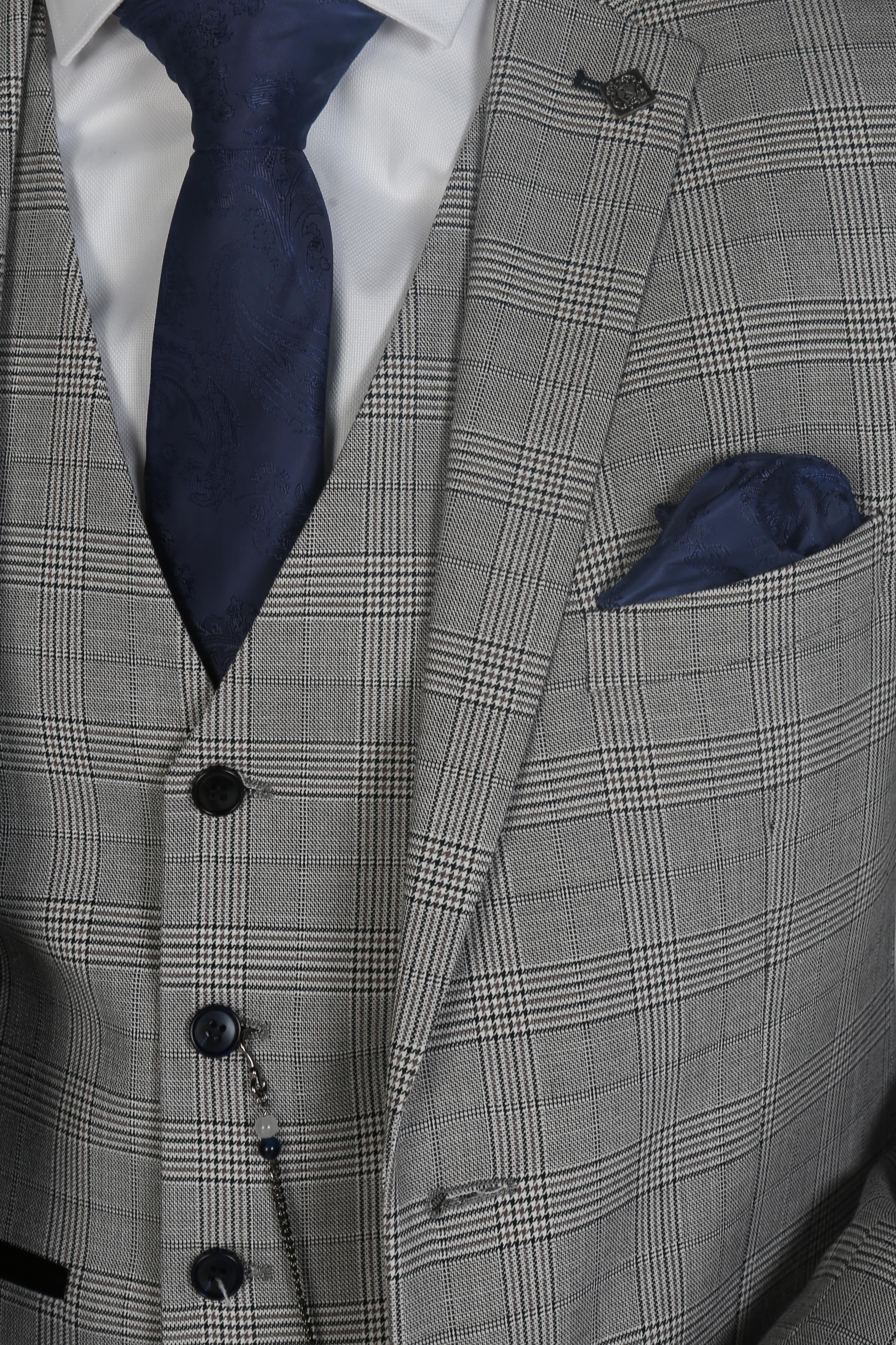 Close-up of the upper part of a Hugo grey checkered three-piece suit with a white dress shirt and blue tie.