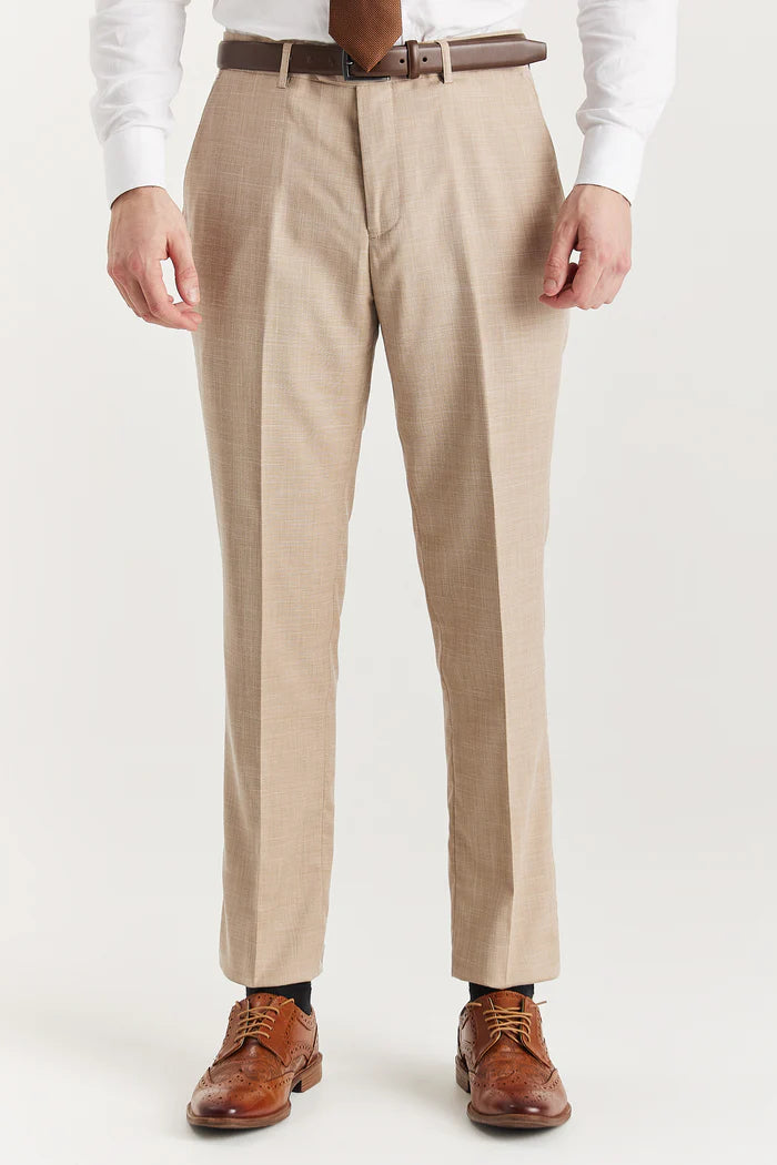 Front view of beige suit trousers featuring a sharp crease, paired with a brown leather belt and dress shoes.