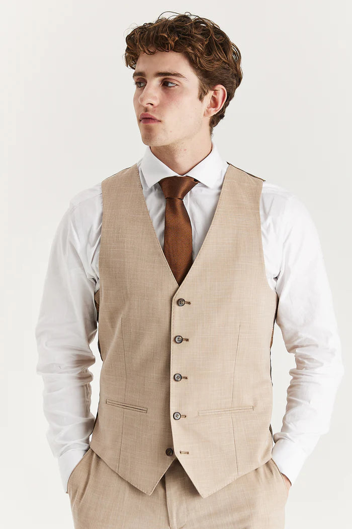 Front view of the beige waistcoat paired with a white shirt and brown tie, showing button detail and slim fit.