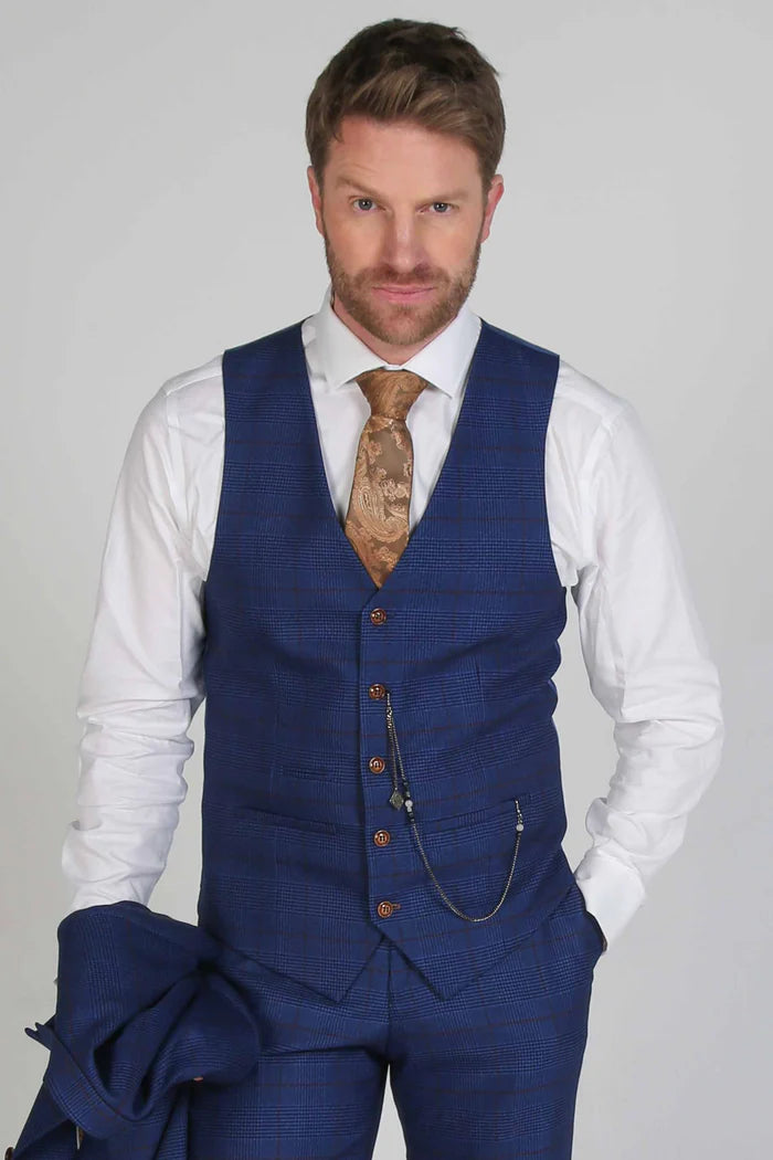 Front view of the Alex navy colour waistcoat, styled with gold tie and chain detailing