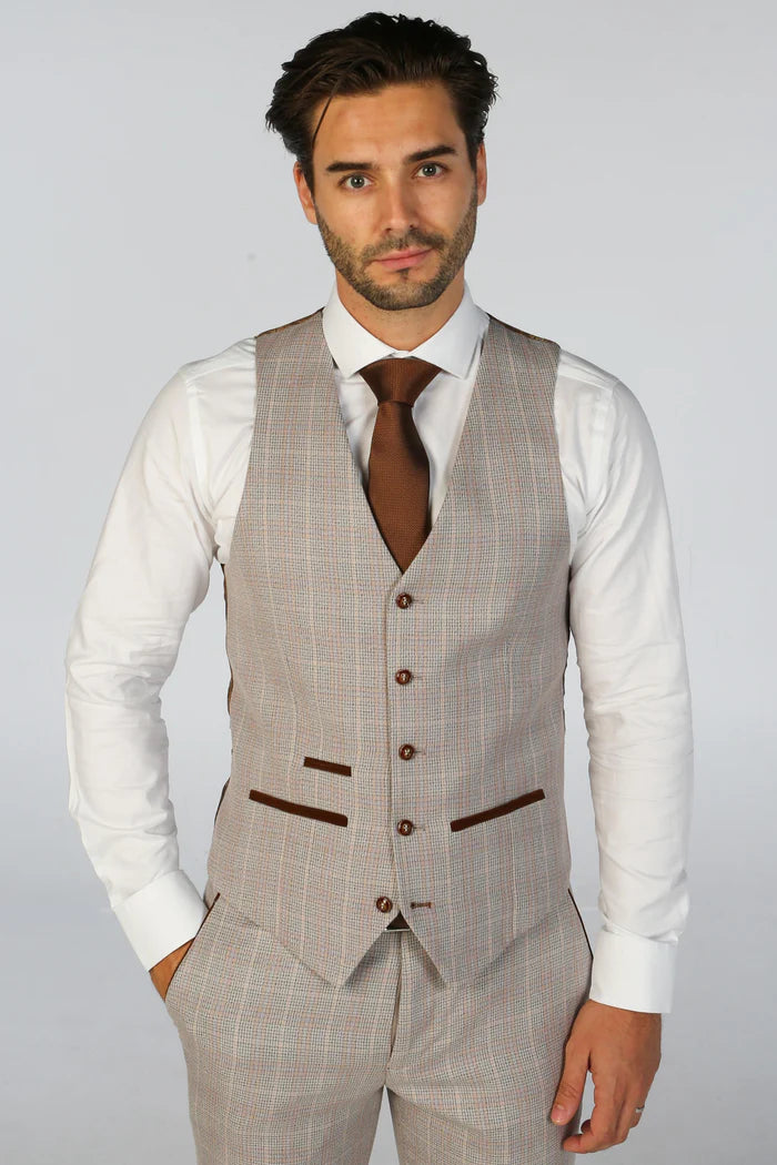 Man wearing beige check waistcoat with brown detailing and white shirt, captured from the front.