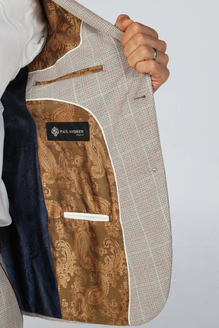 Inside view of beige suit jacket revealing goldish brown paisley lining and Paul Andrew branding for premium finish.