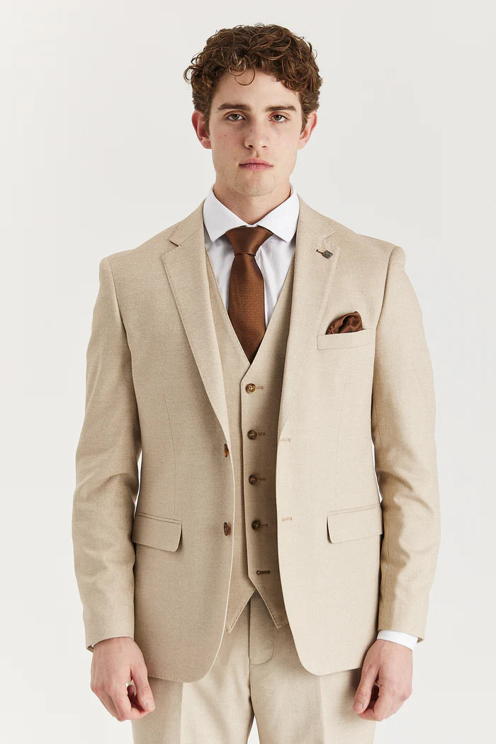Front close-up of model wearing Paul Andrew Belmont Beige three-piece suit with brown tie and pocket square.