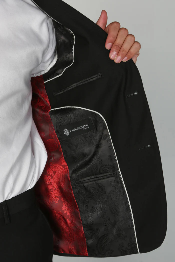 Closeup of the interior lining of the black suit jacket showcasing black and red paisley satin design and Paul Andrew label.