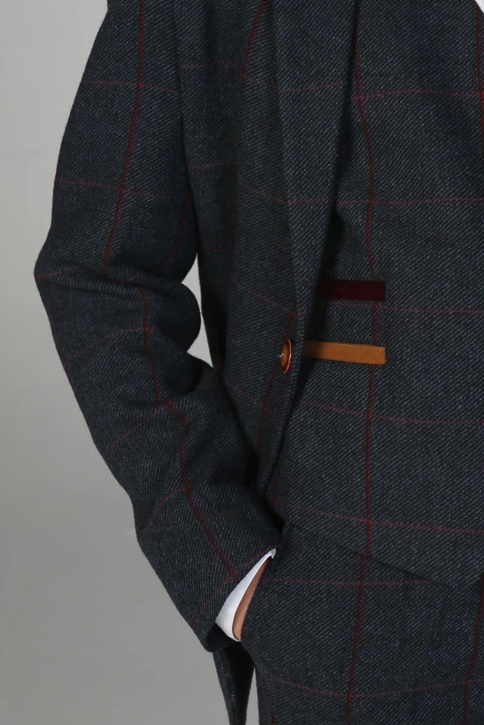 Close-up of navy check suit showing burgundy and mustard pocket trim and brown button accents.