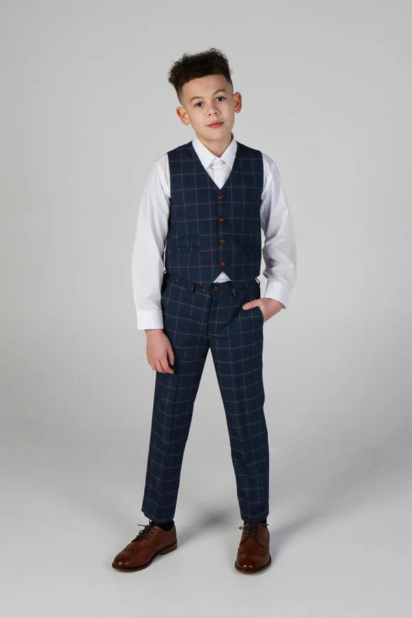 Young boy wearing navy windowpane waistcoat and matching trousers with white shirt, jacket removed for casual formal look.