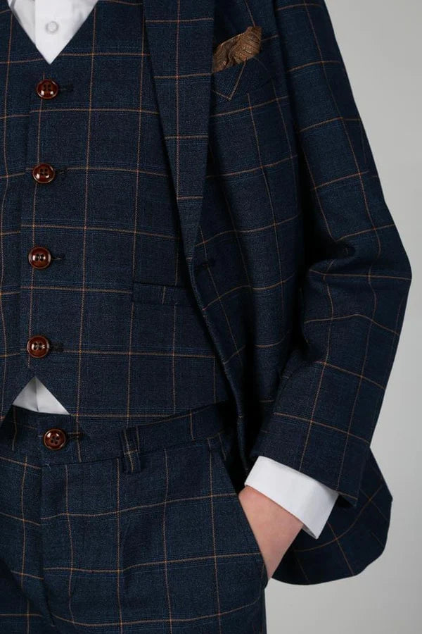 Close-up of navy windowpane check pattern on boys three-piece suit with pocket detail and brown buttons.