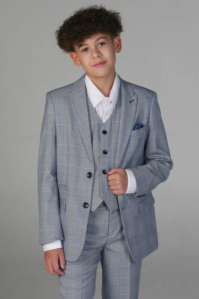 Boy wearing a sky blue check three-piece suit with waistcoat and blue pocket square over a white shirt.