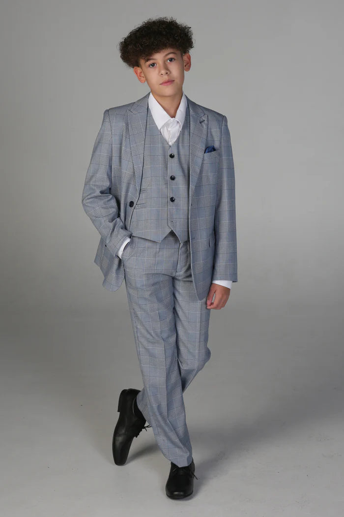 Full body shot of boy in light blue checkered suit with matching waistcoat and trousers, styled with black shoes.