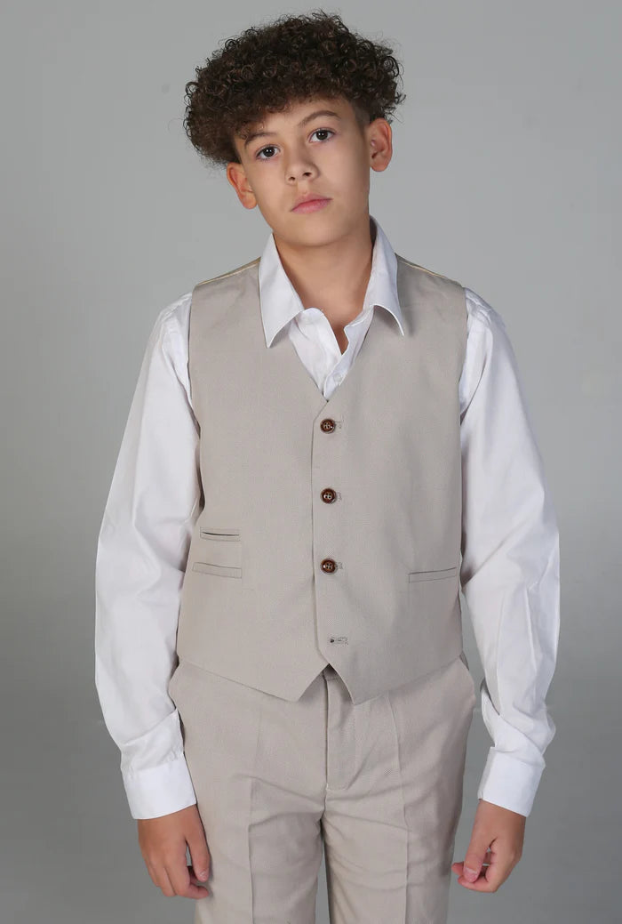 Boy wearing a stone waistcoat and matching trousers over a crisp white shirt.