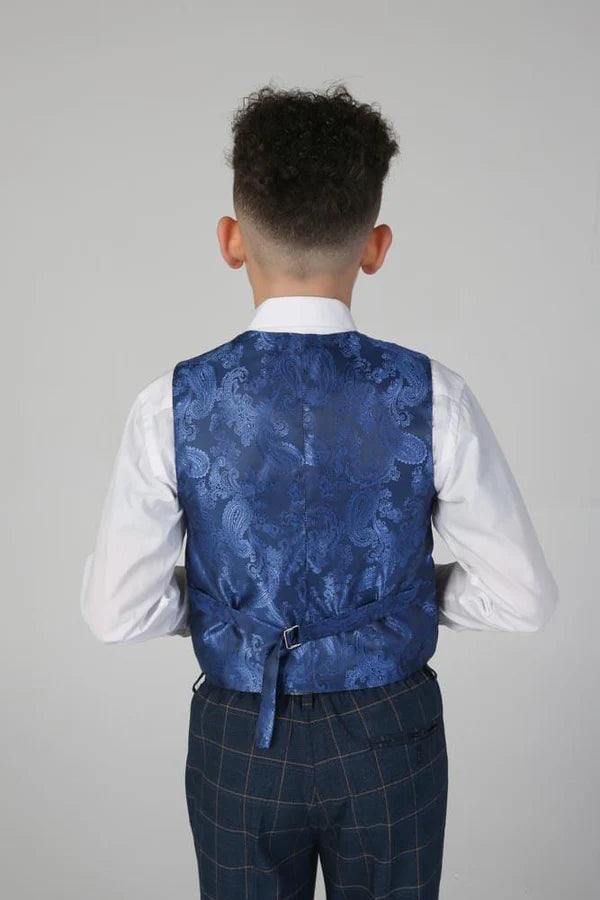 Back view of boy wearing navy check trousers and waistcoat showing blue paisley pattern lining and adjustable strap.