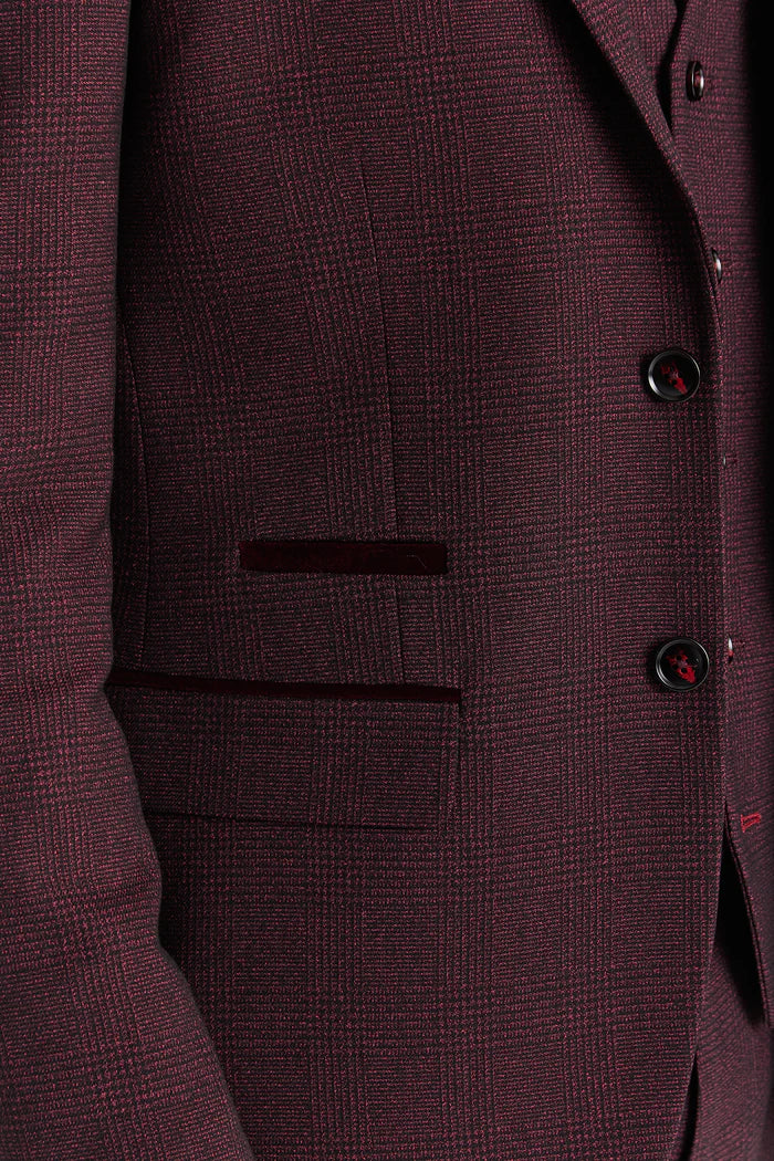 Close-up detail of blazer pocket showing textured burgundy check fabric and dark red velvet trim.