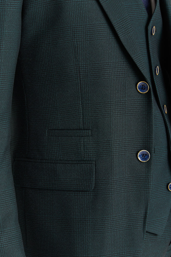 Close-up of the green check blazer showing the textured pattern, buttons, and front pocket stitching.