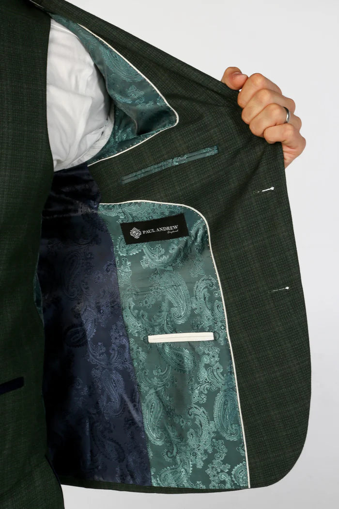 Inside of the green suit jacket featuring teal and navy paisley satin lining and Paul Andrew logo label.
