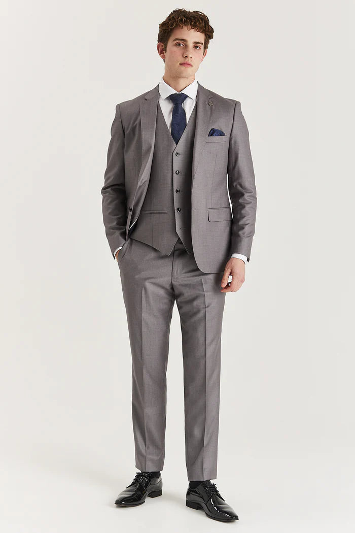 Full-length view of a model wearing a tailored grey three-piece suit, styled with a white shirt and navy tie.