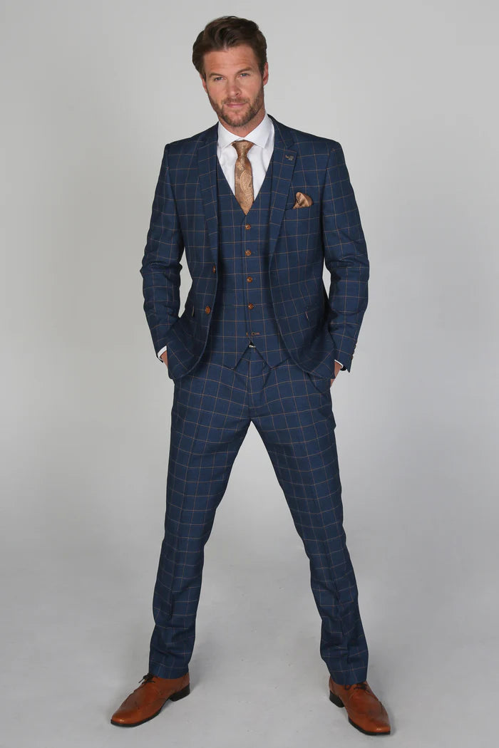 Full-body view of the Hamleys Men's Navy Check Three-Piece Suit, styled with brown tan shoes, a gold tie, and matching pocket square.