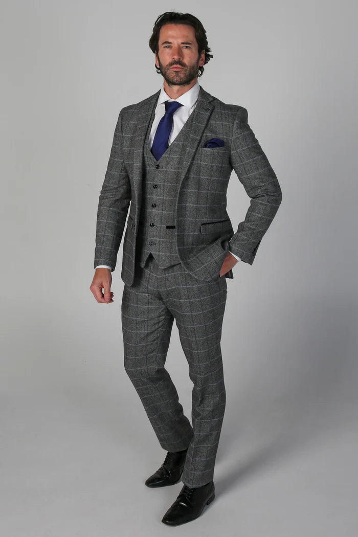 Full front view of the Harris Grey Tweed Check three-piece suit, including a grey check jacket, waistcoat, and tailored trousers paired with a blue tie.