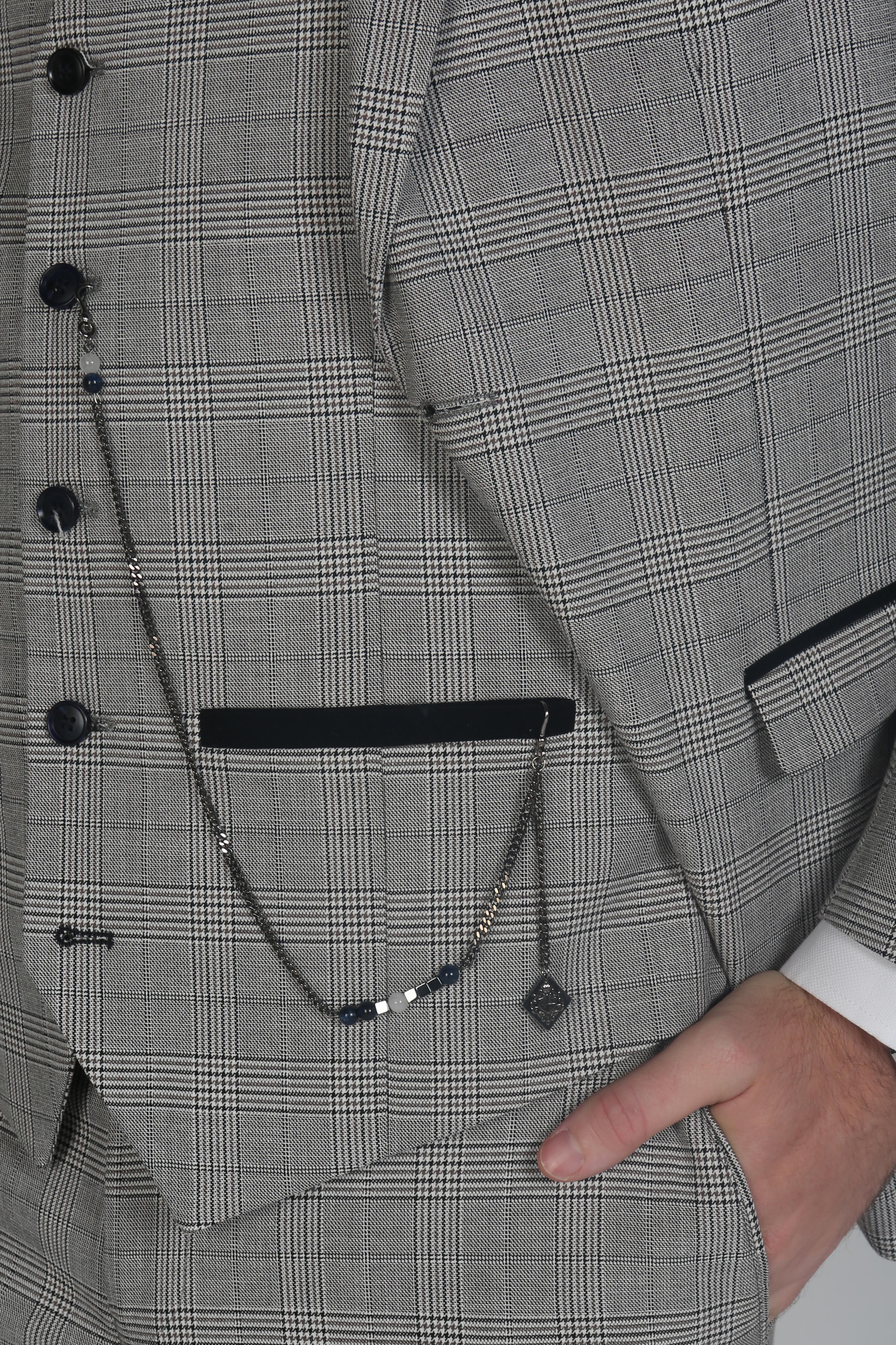 Close-up of the pocket watch chain detail on a Hugo grey checkered three-piece suit.