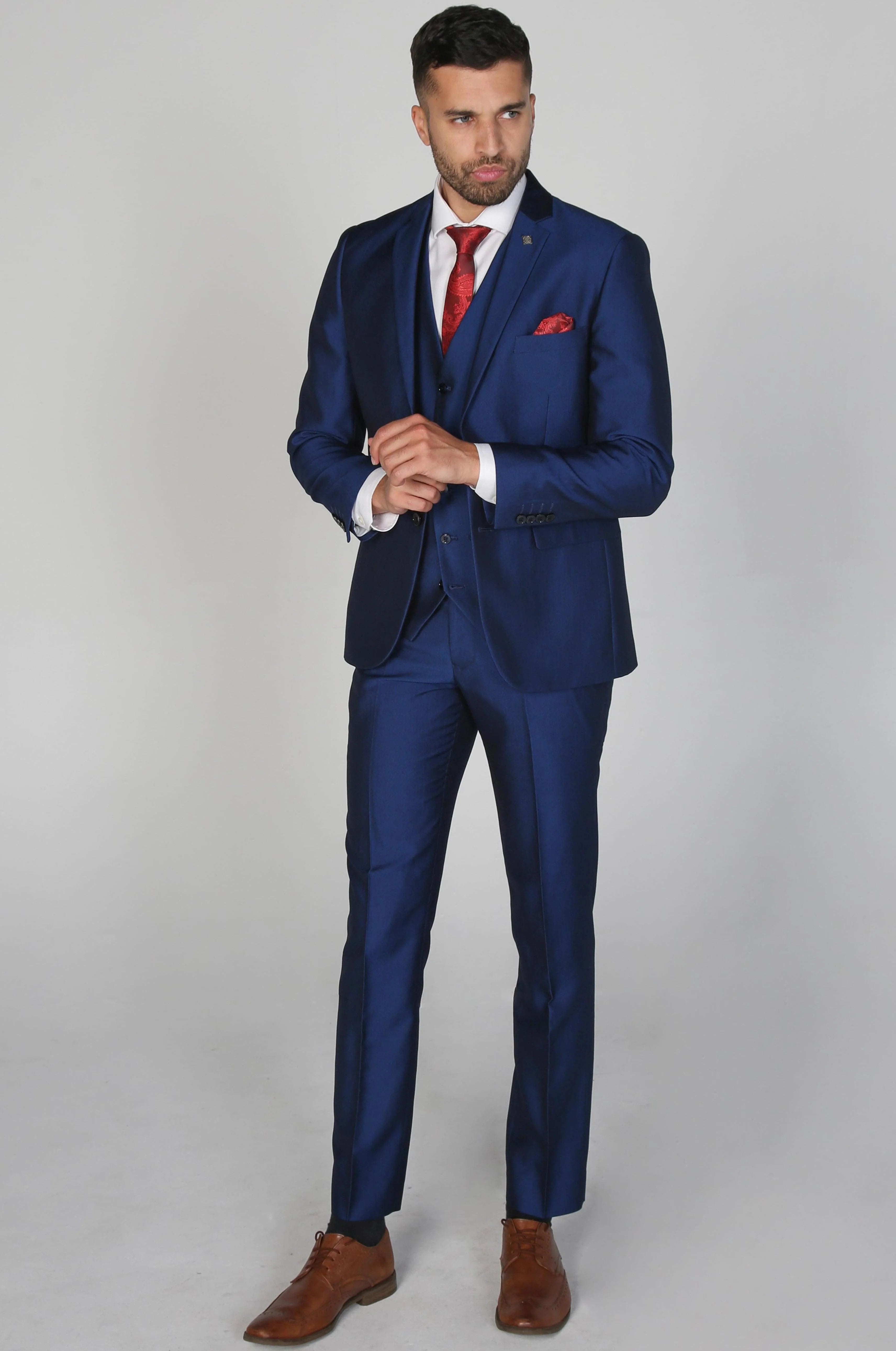 Full view of Kingsley Blue Men's three-piece suit with a white dress shirt and red tie, model standing.