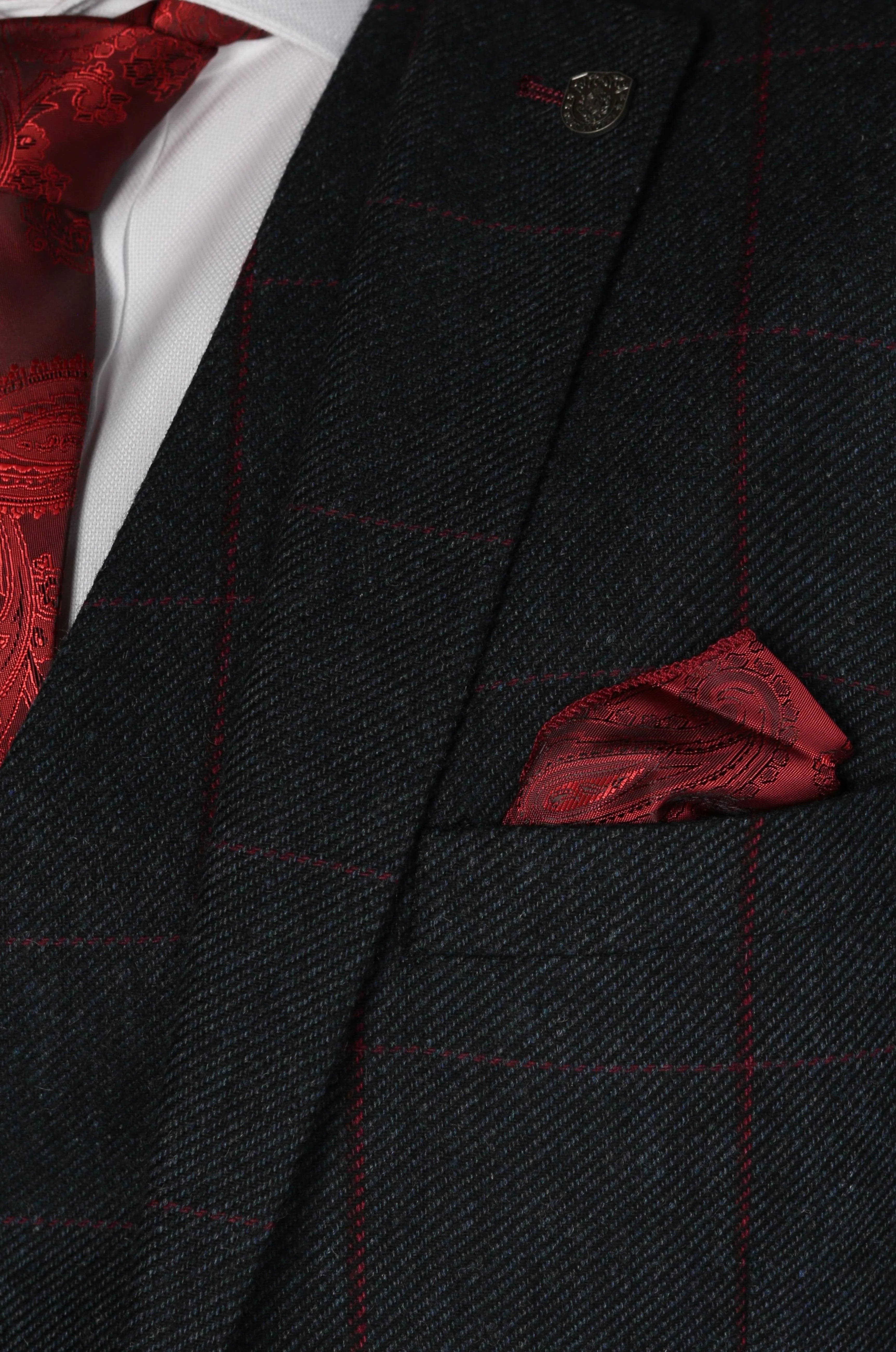 Close-up of the pocket detail on the Madrid Men's Navy Tweed Checkered Three Piece Suit featuring a red patterned pocket square and matching tie.
