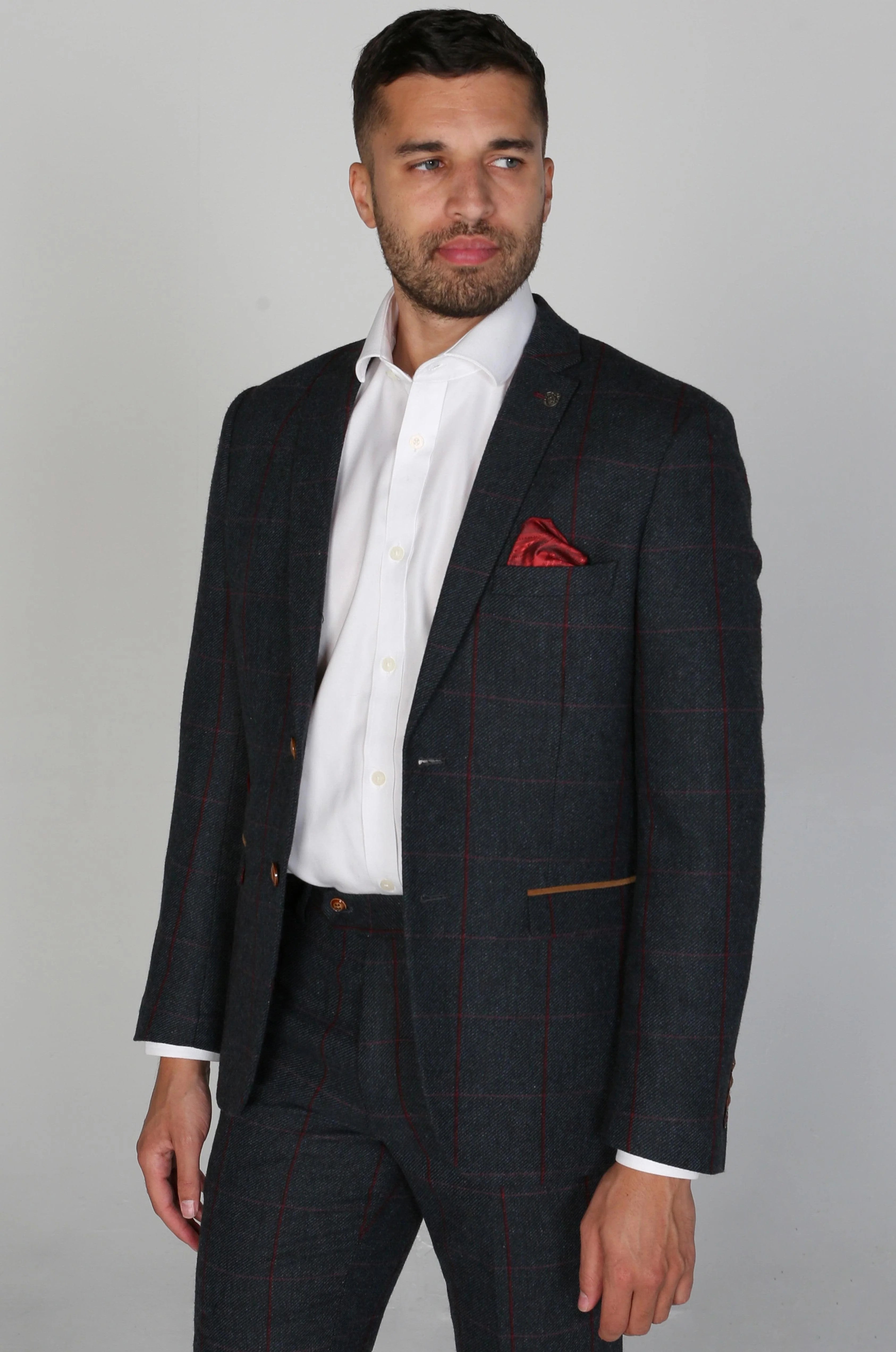 Front view of the Madrid Men's Navy Tweed Checkered Three Piece Suit jacket, showcasing the elegant design with a red pocket square and white dress shirt.
