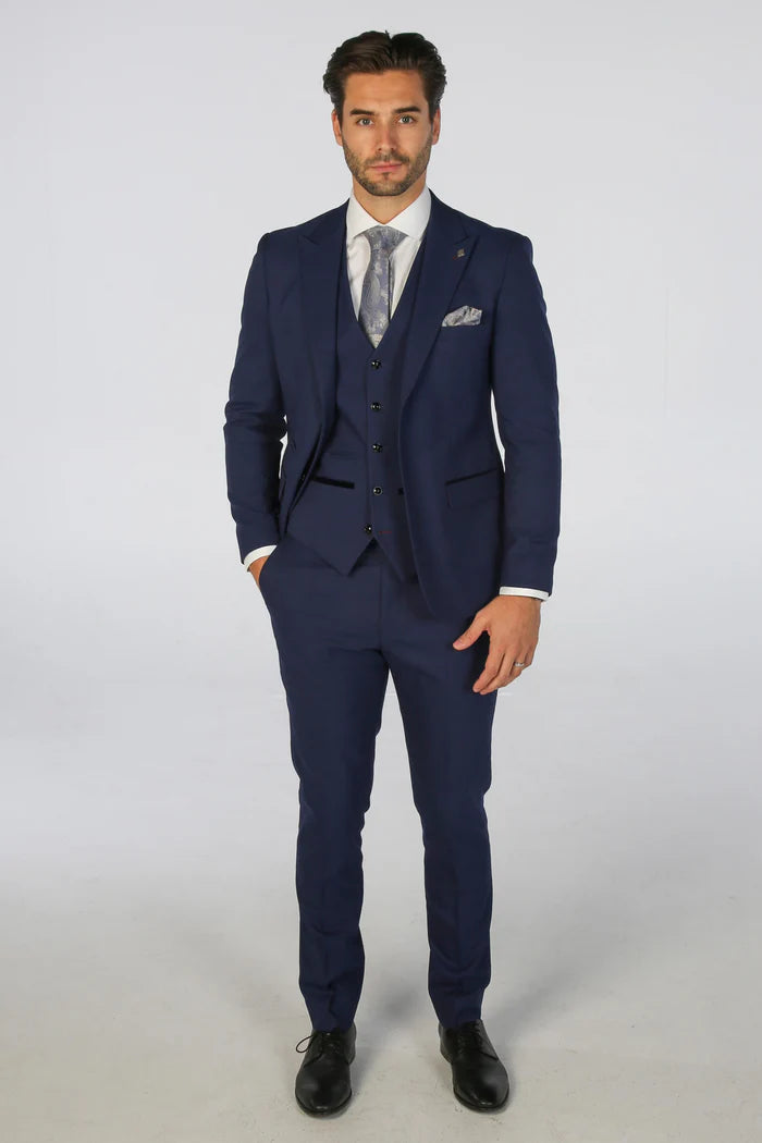 Full-length image of a model dressed in the Mark blue check three-piece suit with black formal shoes.