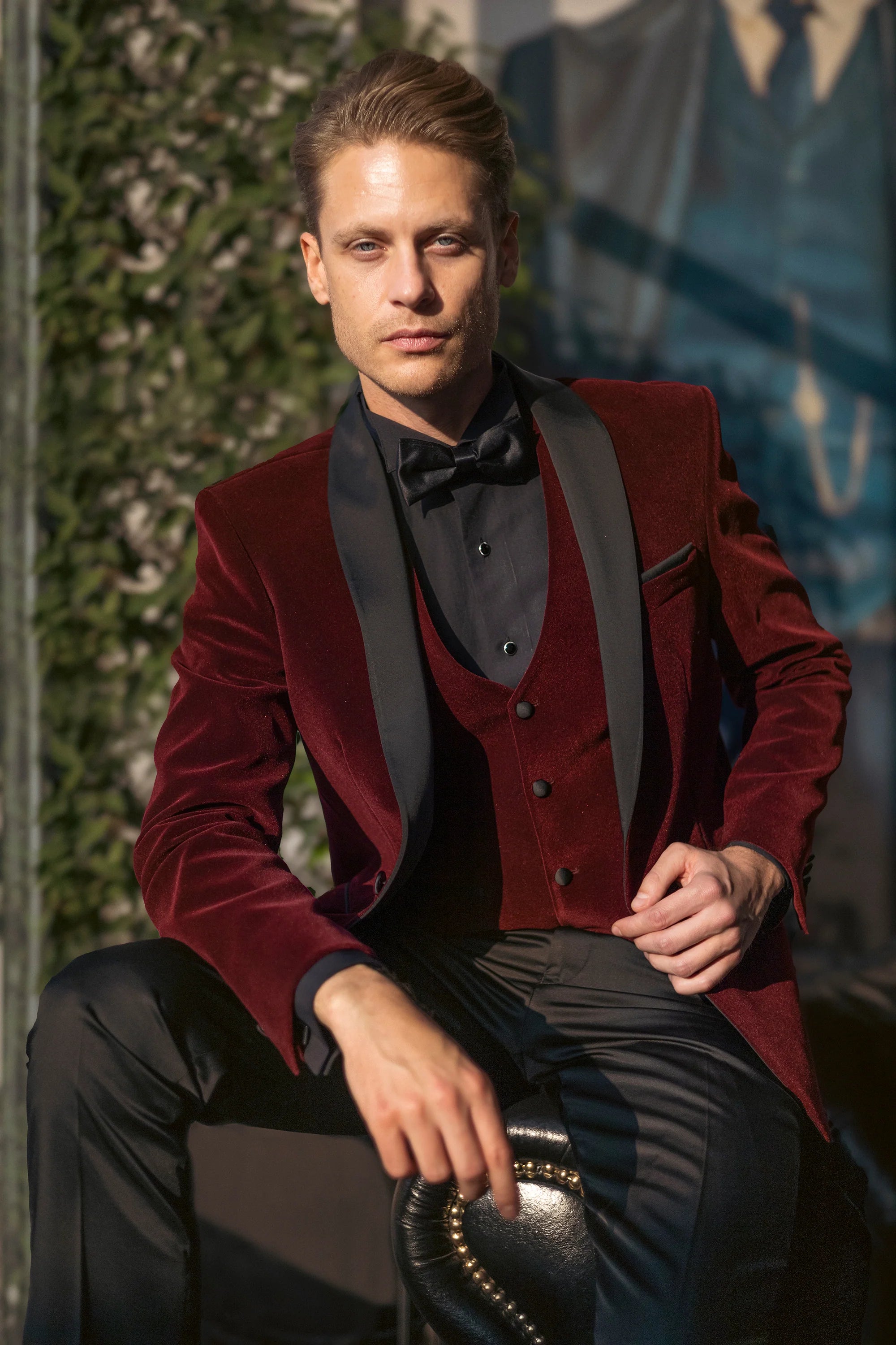 Wine burgundy velvet dinner jacket with black satin shawl lapels and matching waistcoat, front seated view