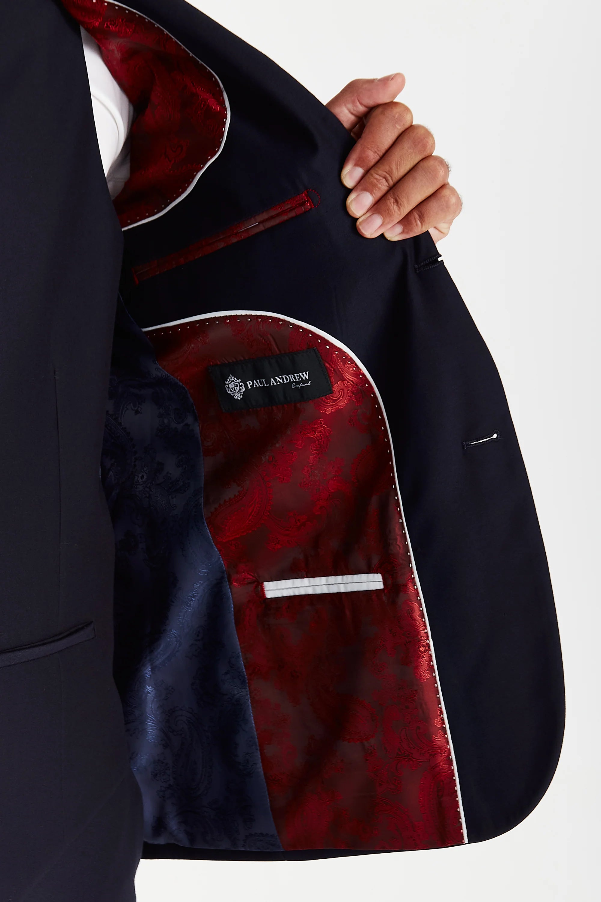 Interior view of the navy blazer with red and navy paisley lining and a visible Paul Andrew logo label.