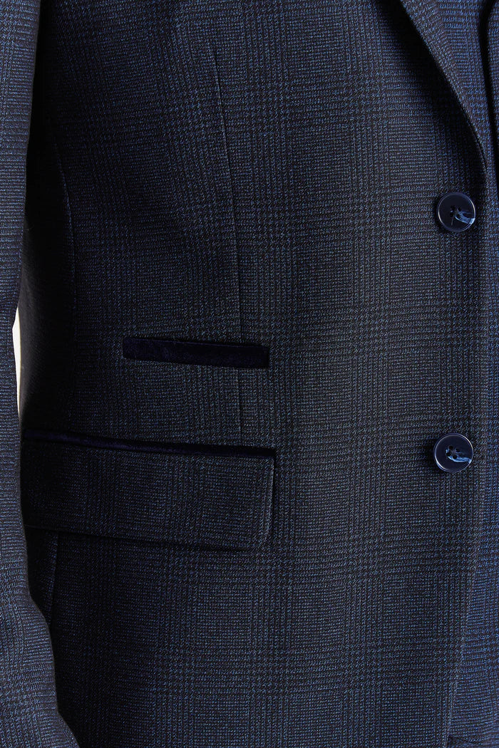 Close-up of the blazer pocket on navy check fabric with contrast velvet trim and dark navy buttons.