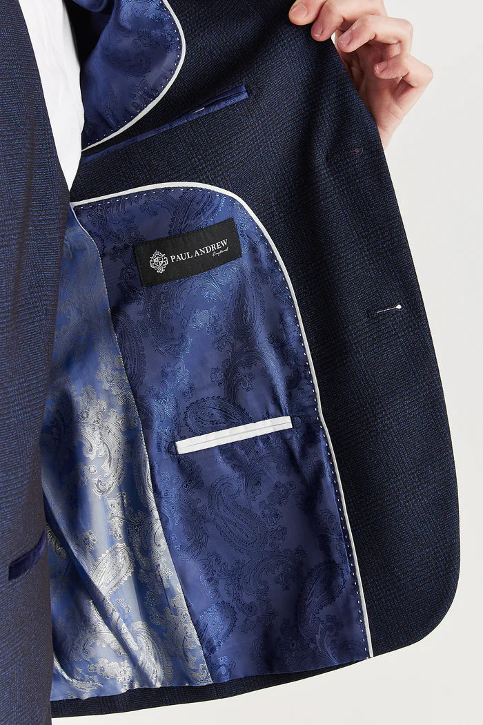 Inner jacket detail of the navy suit featuring luxurious silver and blue paisley satin lining with Paul Andrew branding.