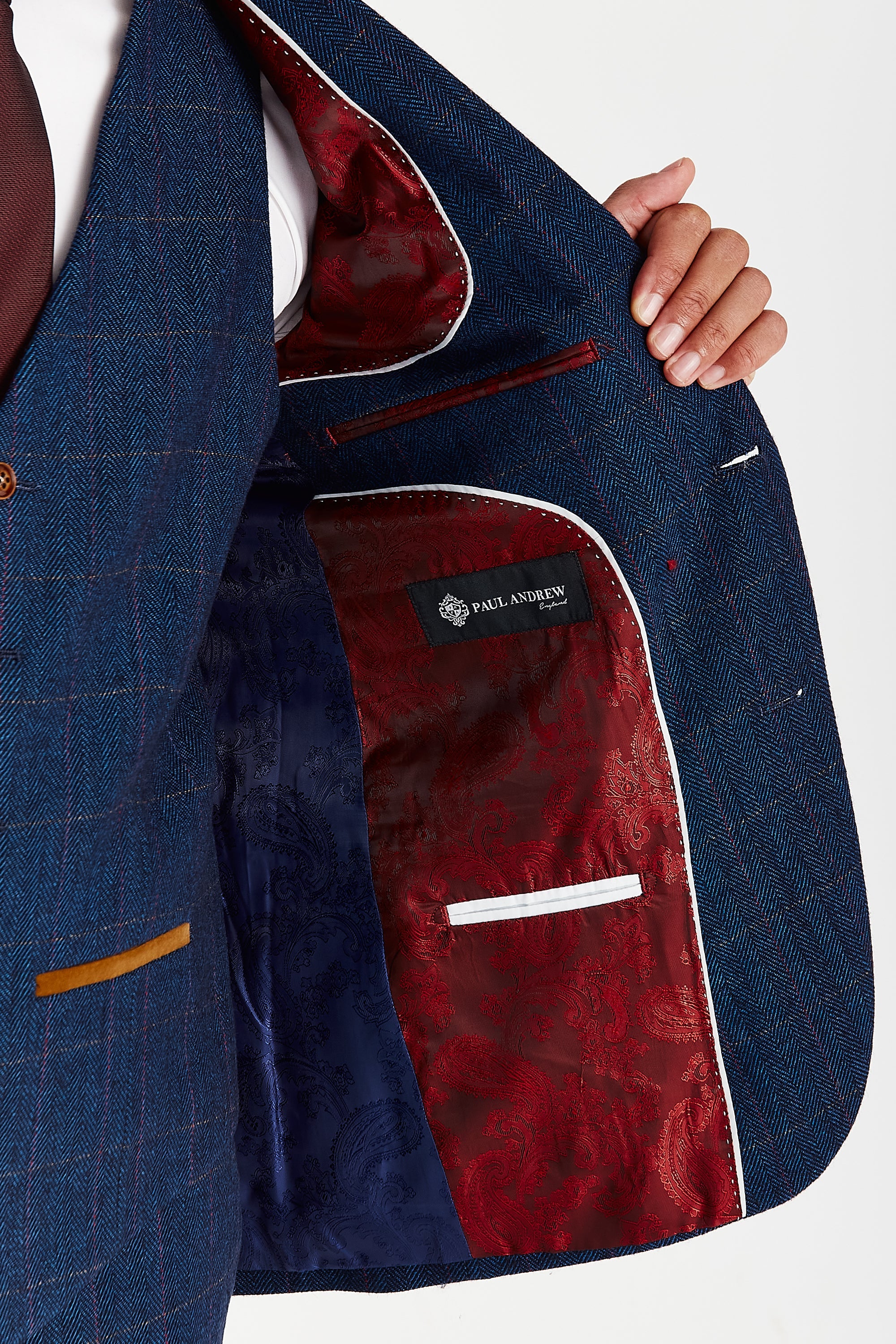 nterior view of the Scott navy tweed check blazer with blue and red paisley lining and a visible Paul Andrew logo label.