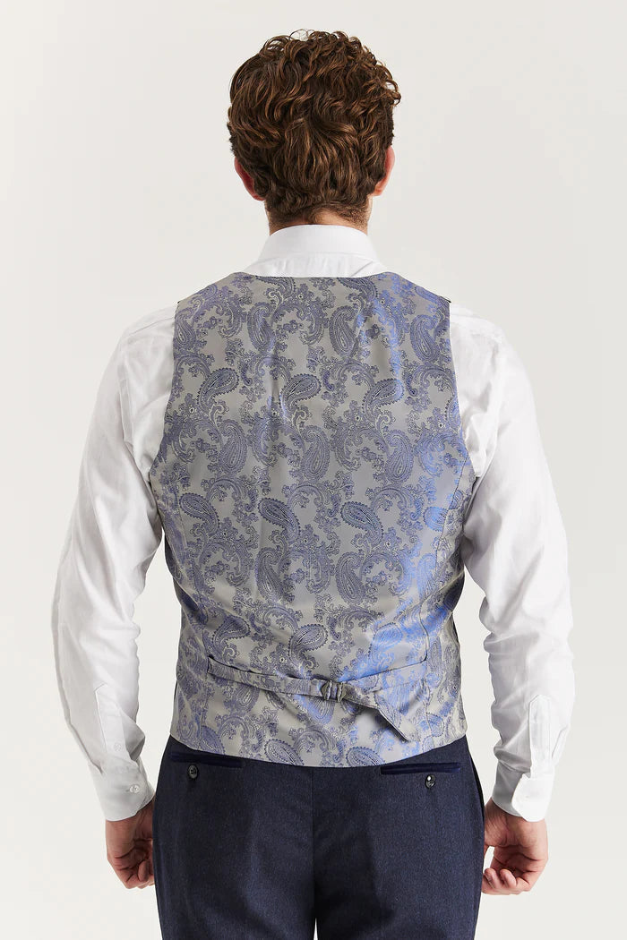 Back view of Oscar navy tweed waistcoat featuring silver-blue paisley satin fabric and adjustable belt.