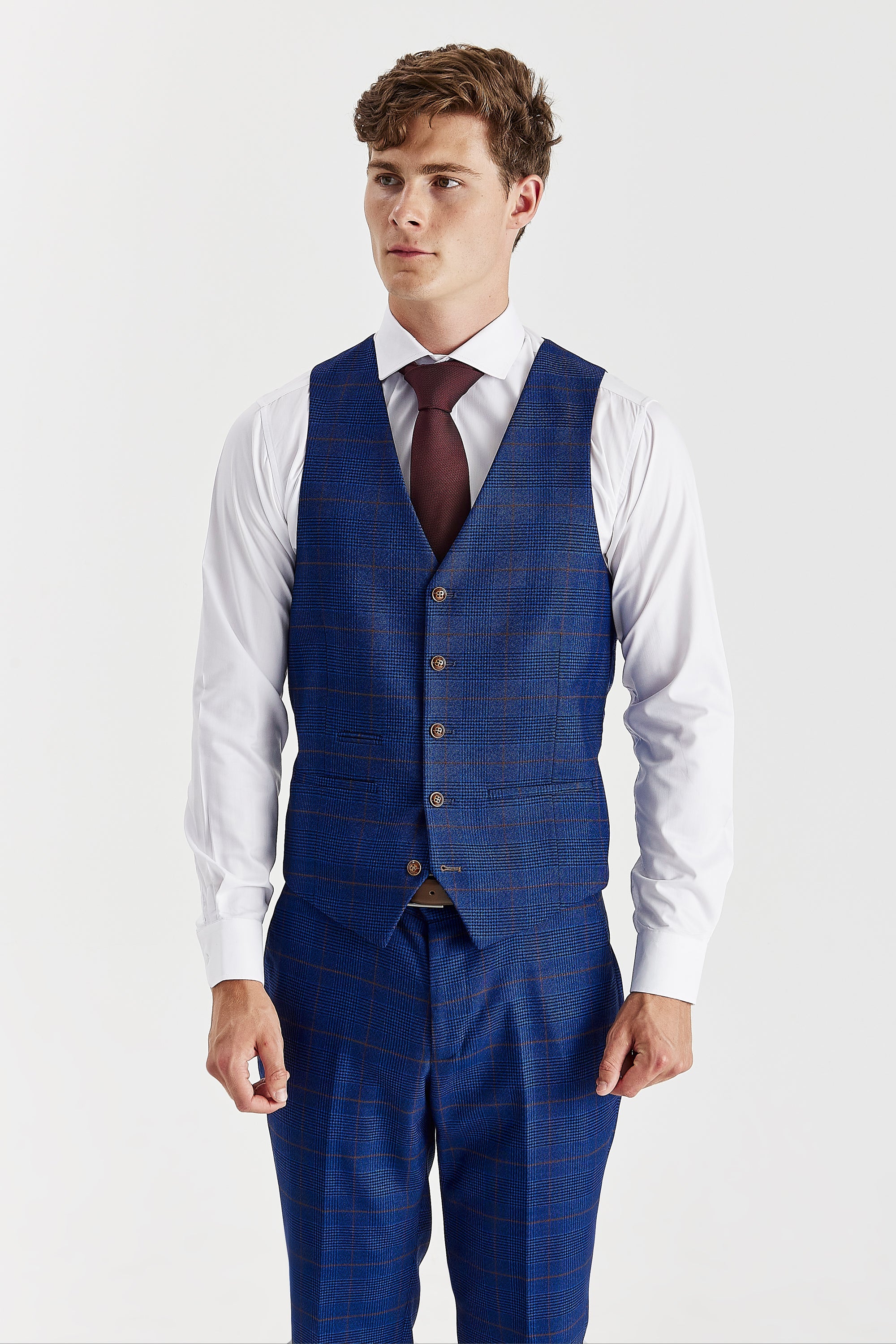 Front view of the navy glen check waistcoat with brown buttons, worn with matching trousers, a white shirt and a burgundy tie.