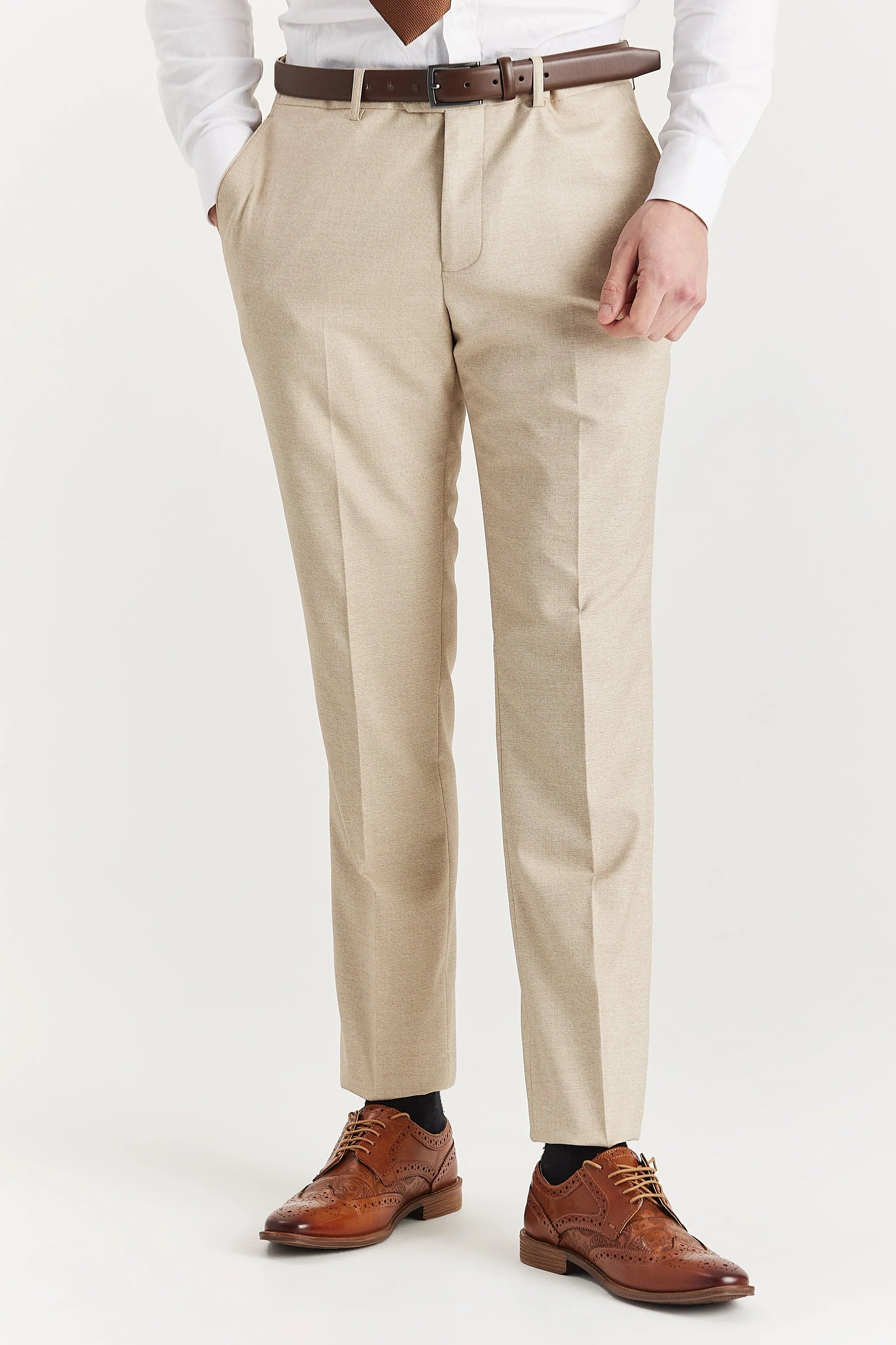 Close-up front view of the Belmont beige suit trousers, featuring a tailored fit, brown leather belt, and brown brogue shoes.