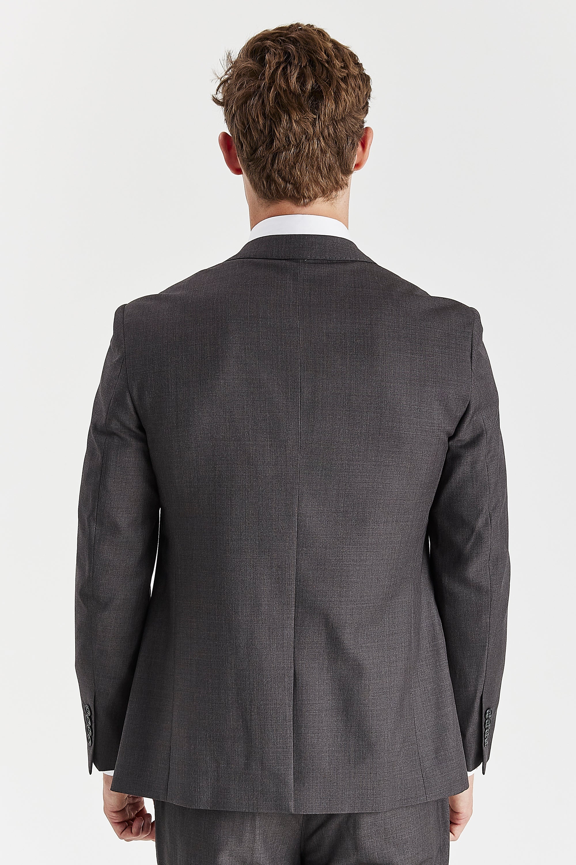Back view of a charcoal suit jacket with matching trousers.