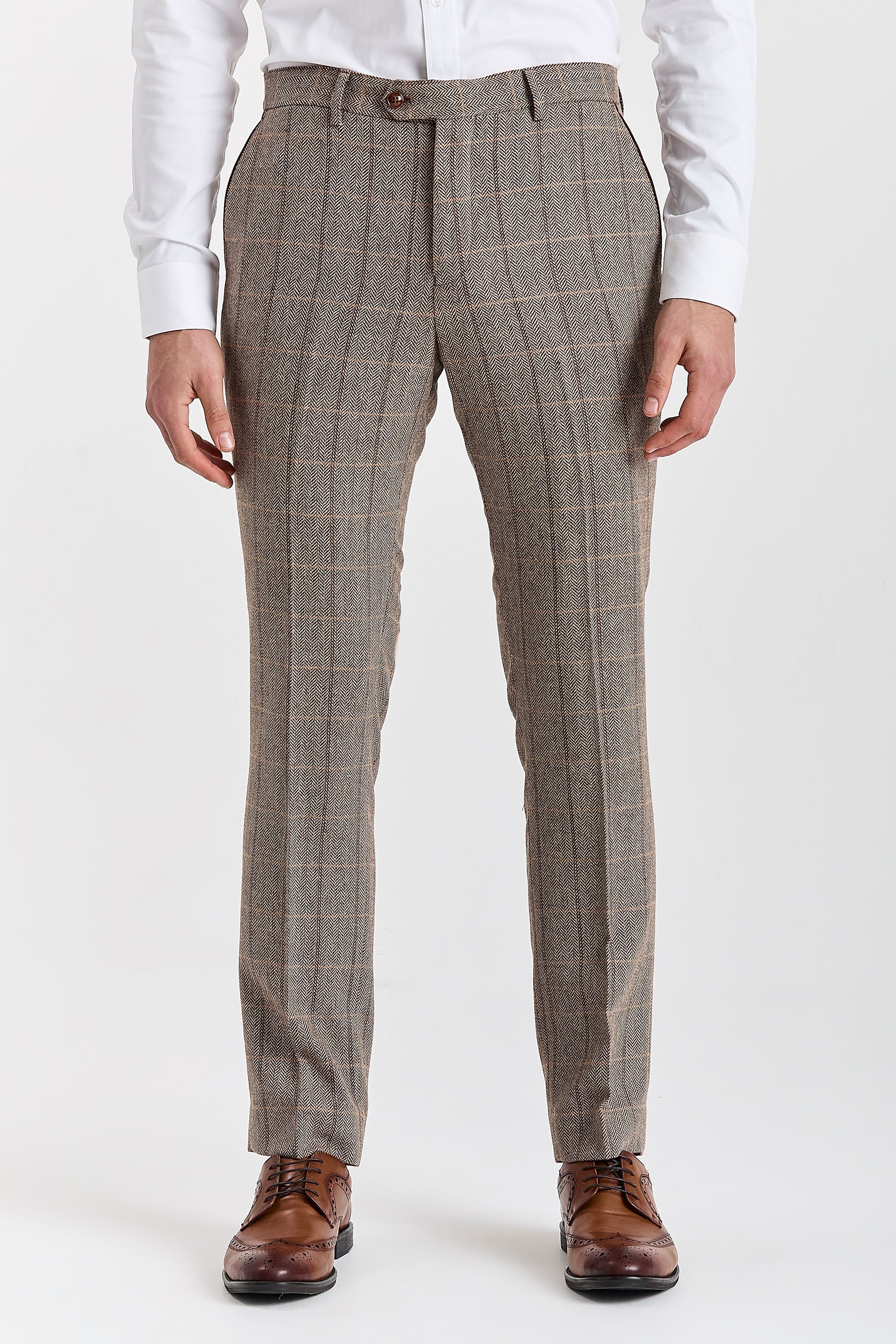 Men’s brown herringbone check trousers shown from the front, worn with the matching waistcoat, white shirt and brown brogues.
