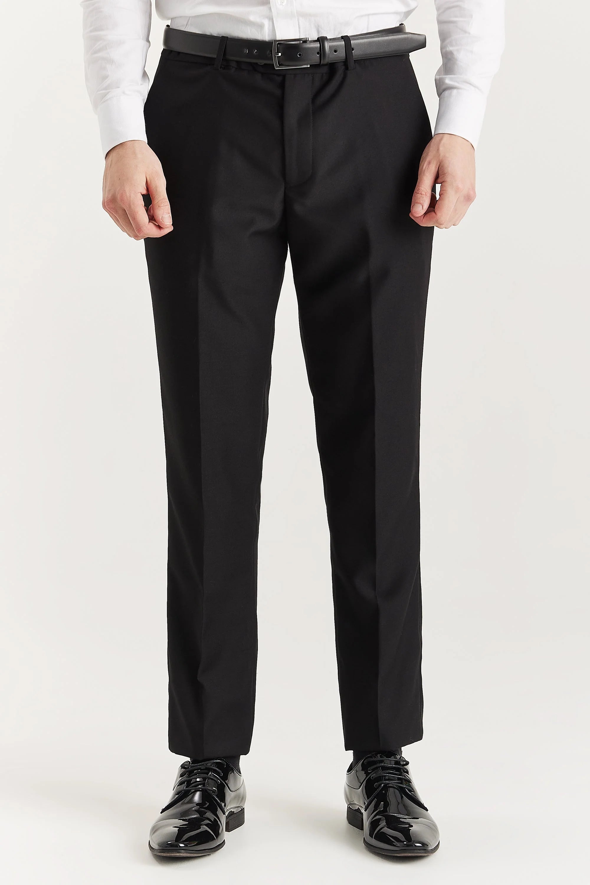Close-up front view of the trousers from the Harry Black Men's Two Piece Tuxedo , paired with a crisp white shirt and polished black dress shoes.