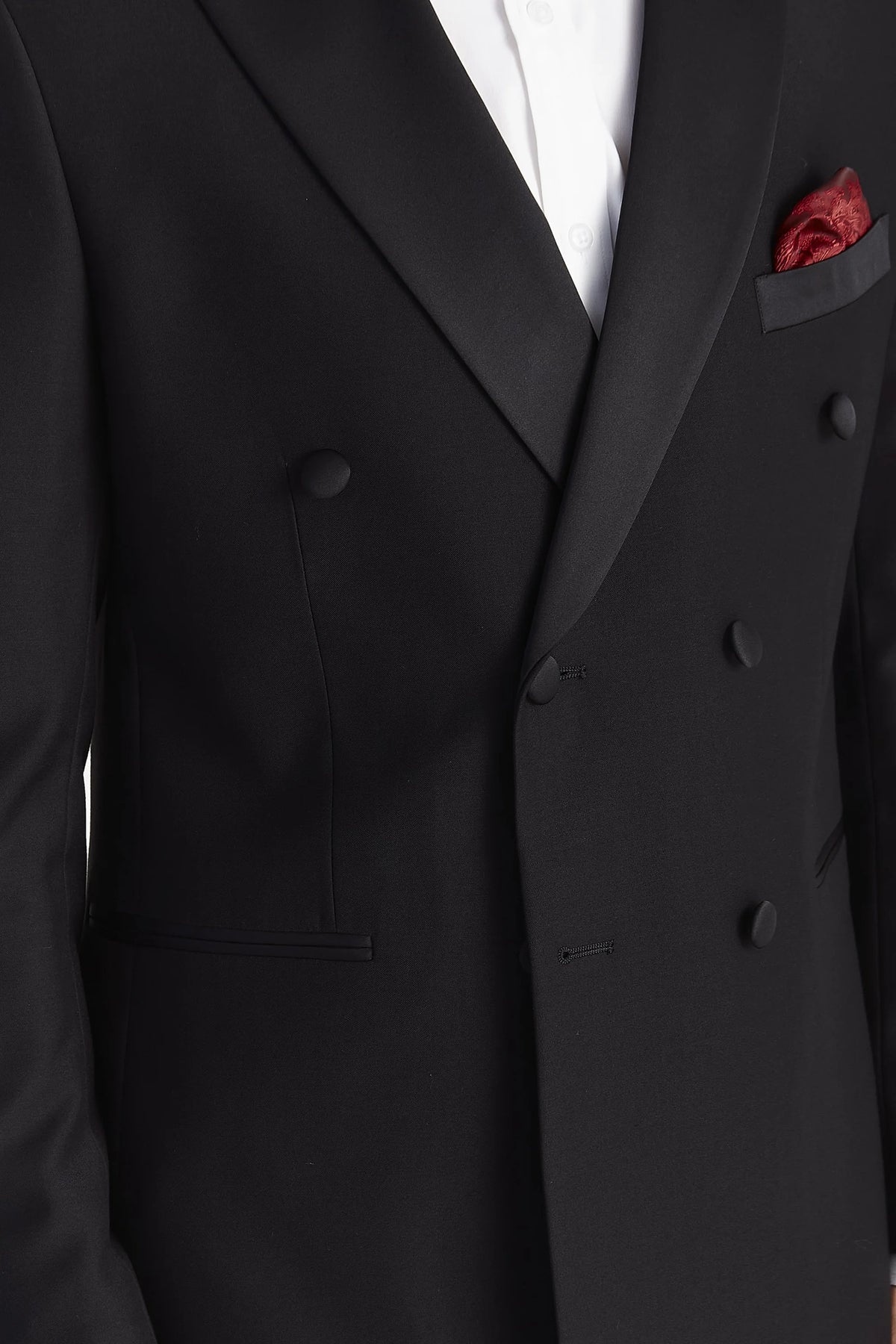 Close-up of the jacket’s smooth satin lapels, overlapping front, black covered buttons and jetted pockets.