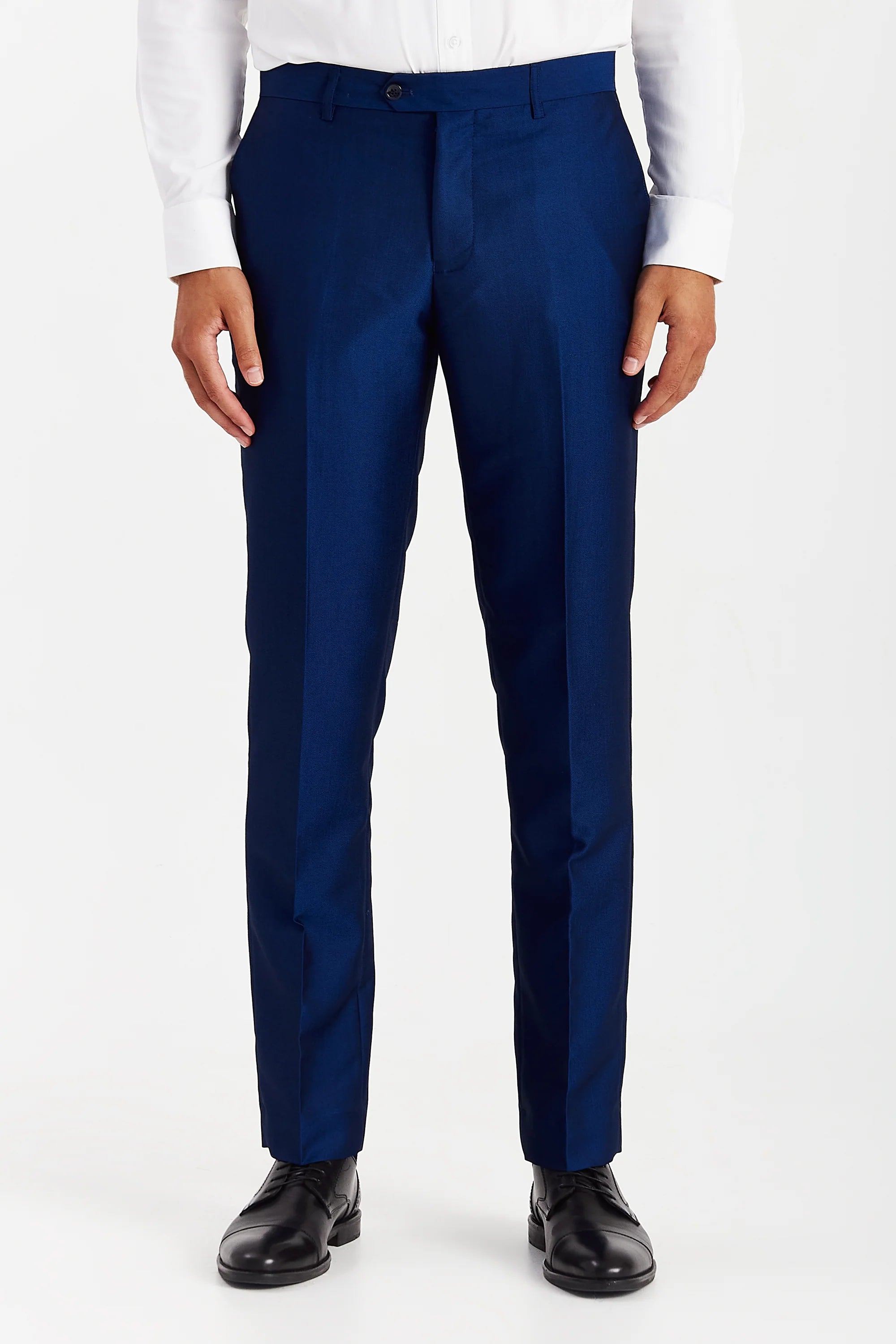 Men’s blue trousers shown from the front, worn with a white shirt and brown brogues.