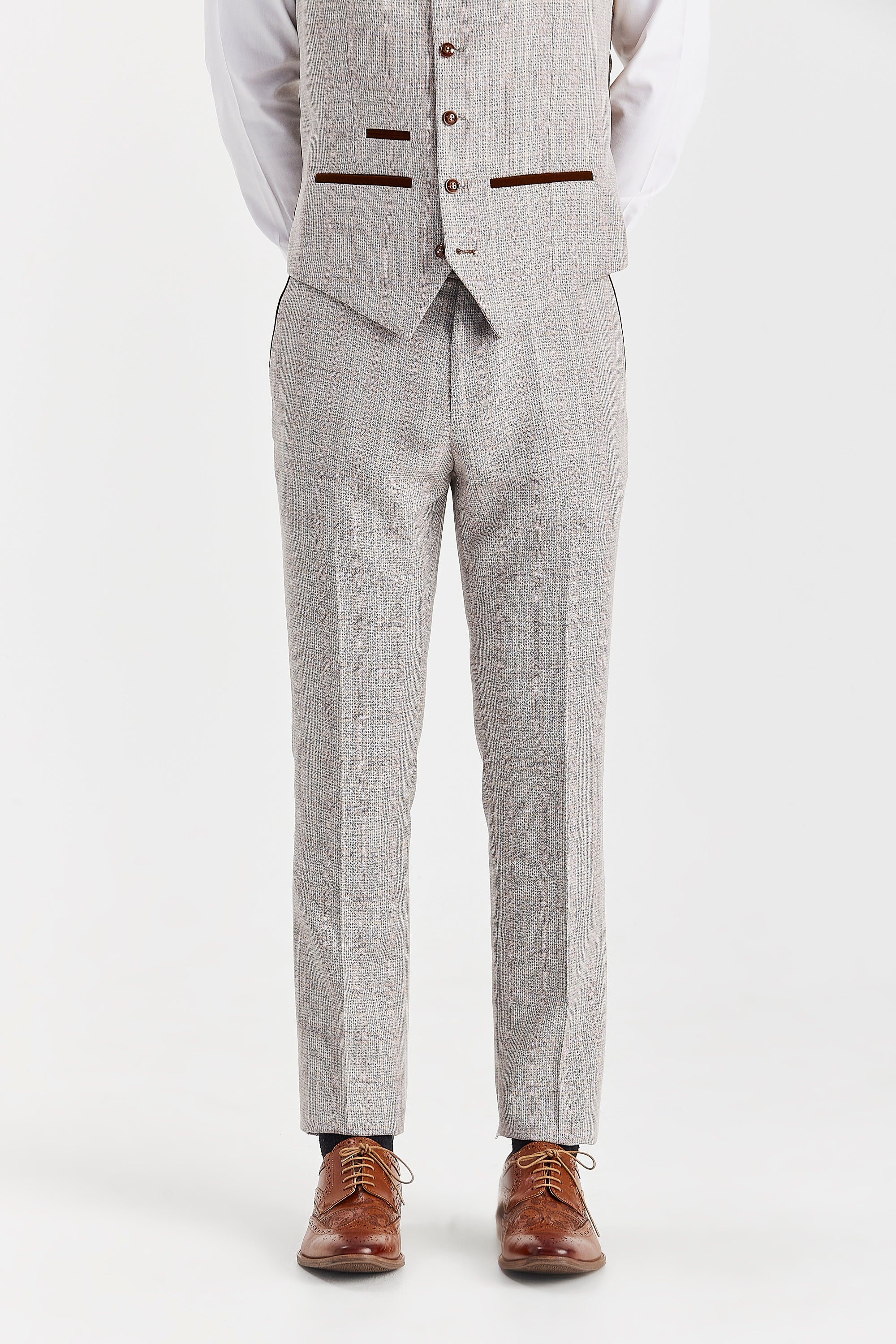 Close-up front view of men's beige checked suit trousers and matching waistcoat, paired with a white shirt and brown shoes.