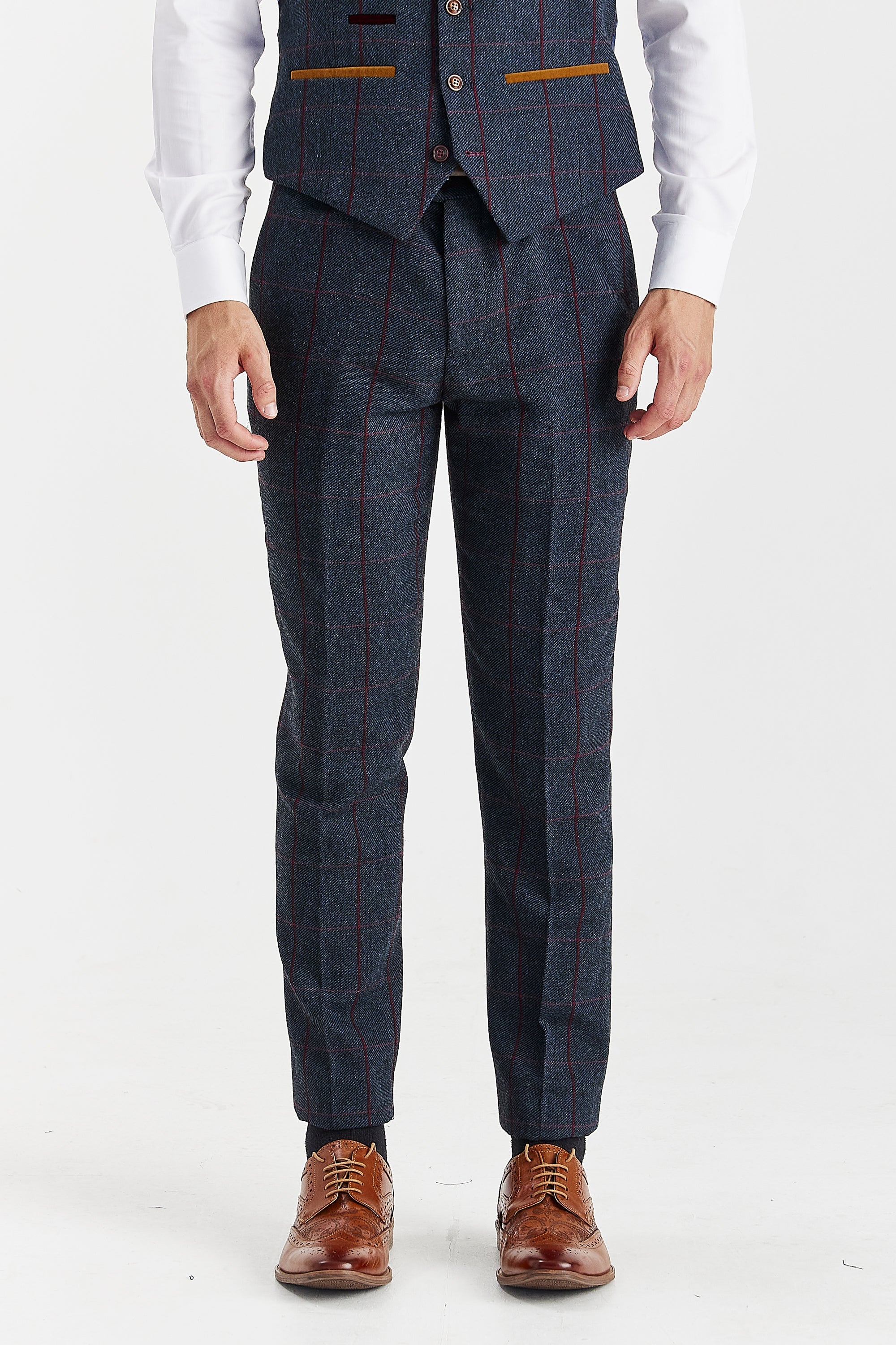 Front view of navy tweed trousers with a burgundy windowpane check pattern, shown with a matching waistcoat, white shirt cuffs and brown shoes.