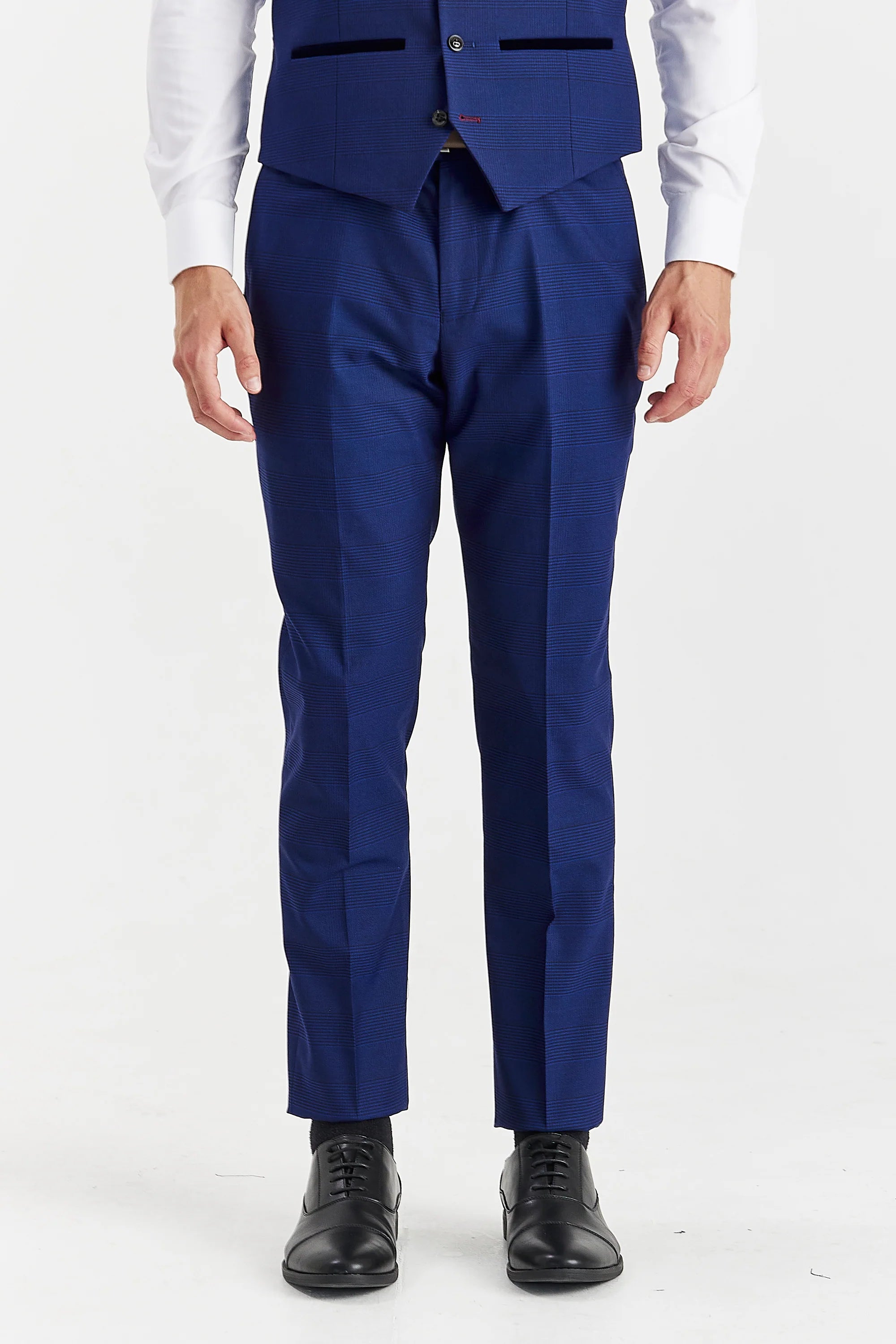 Men’s blue check trousers shown from the front, worn with the matching waistcoat, white shirt and black formal shoes.