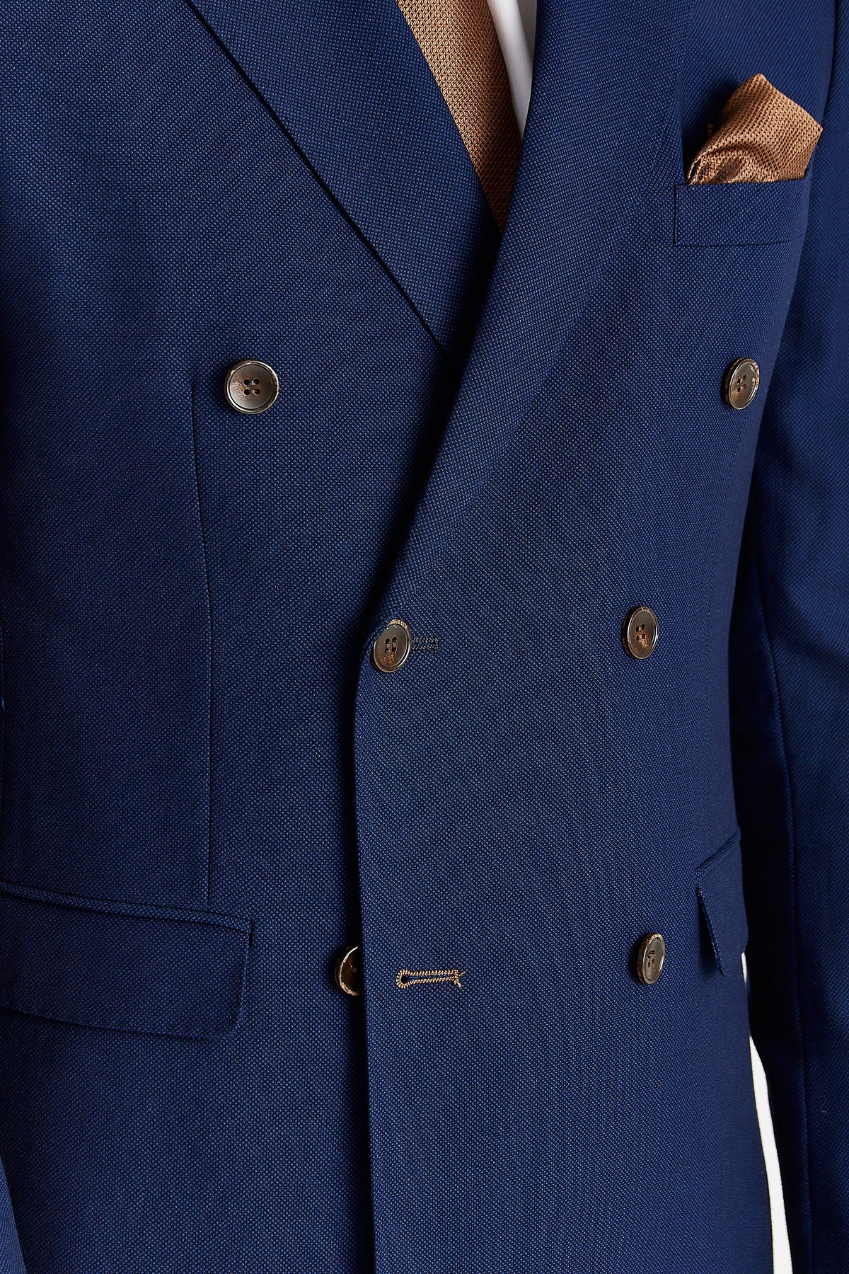 Close-up showing the navy fabric’s woven texture, brown buttons and brown buttonhole stitching.