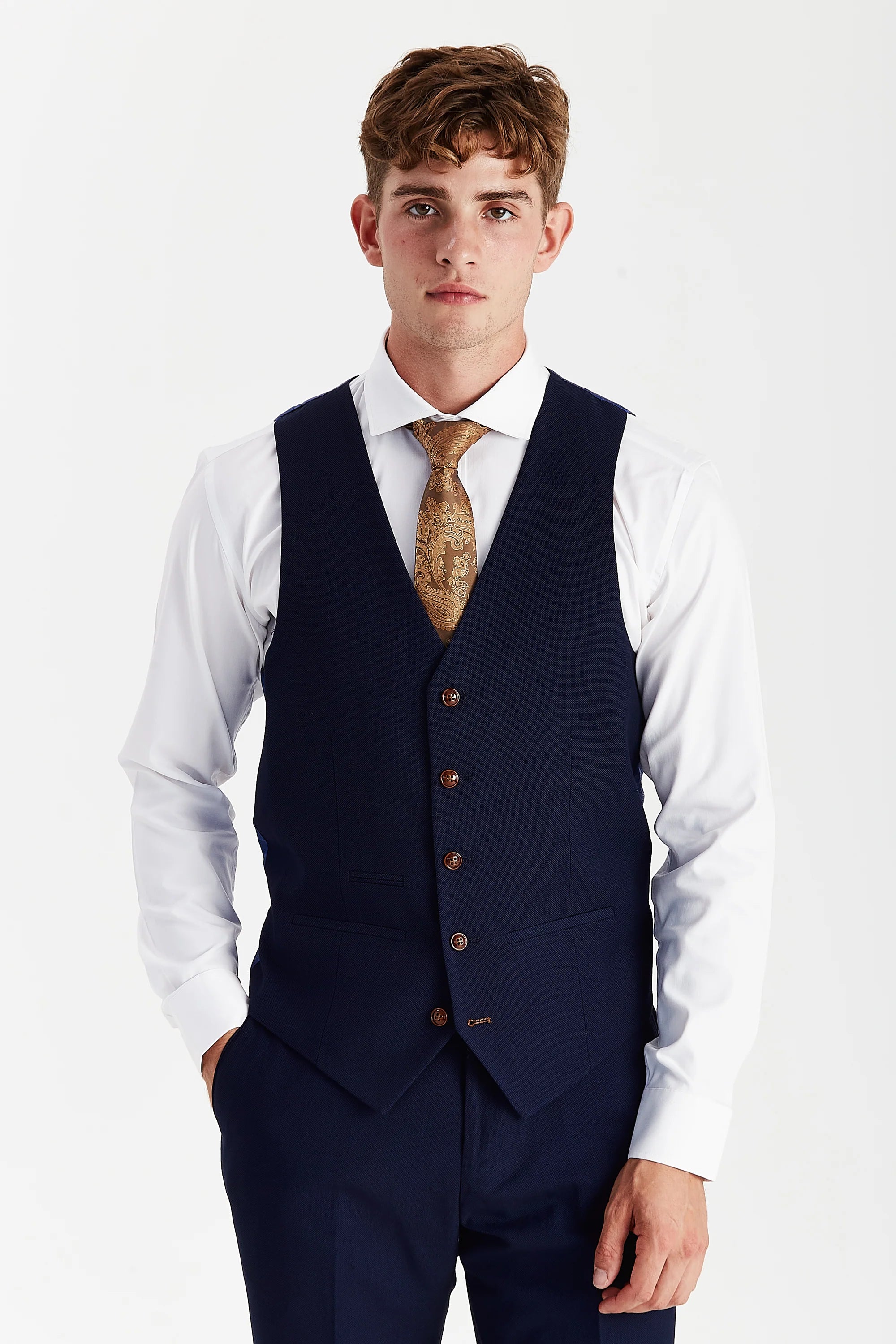 Front view of a navy textured waistcoat with brown buttons, matching trousers, white shirt and gold paisley tie.