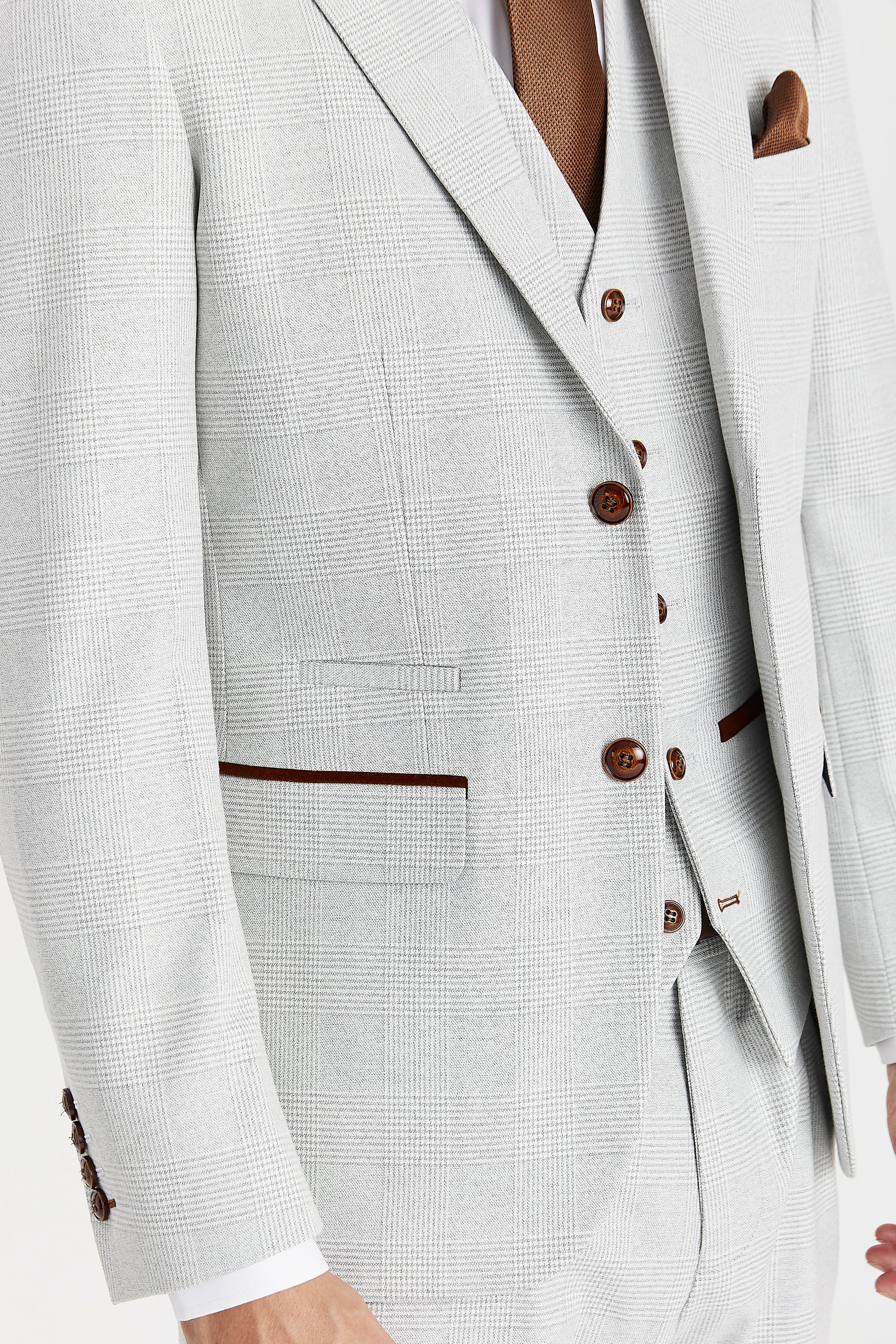 Close-up detail of the single-breasted Mark Men's Stone Check Blazer and matching waistcoat. The image highlights the textured stone-toned glen check pattern, contrasting brown buttons, and warm brown suede trimmings on the pockets