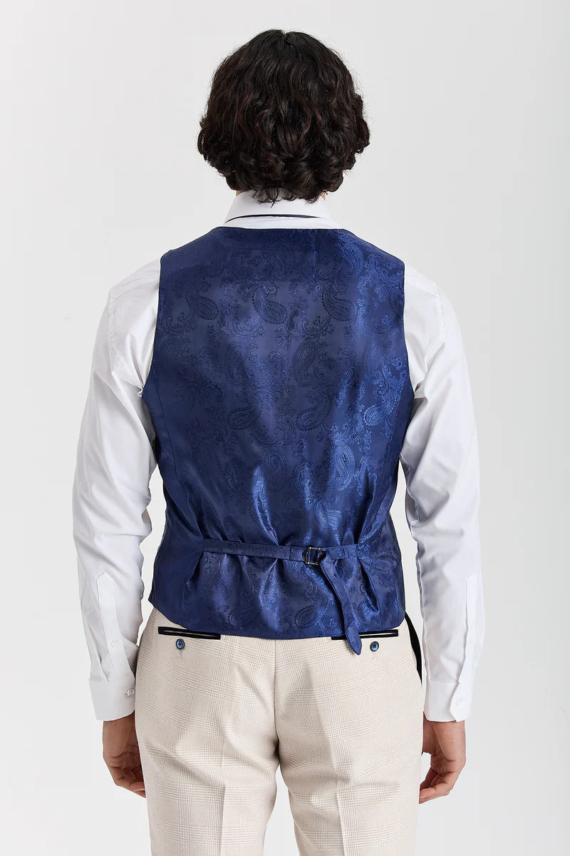 Back view of a men's waistcoat showing a dark blue paisley pattern back panel with an adjustable strap, worn over a white shirt.
