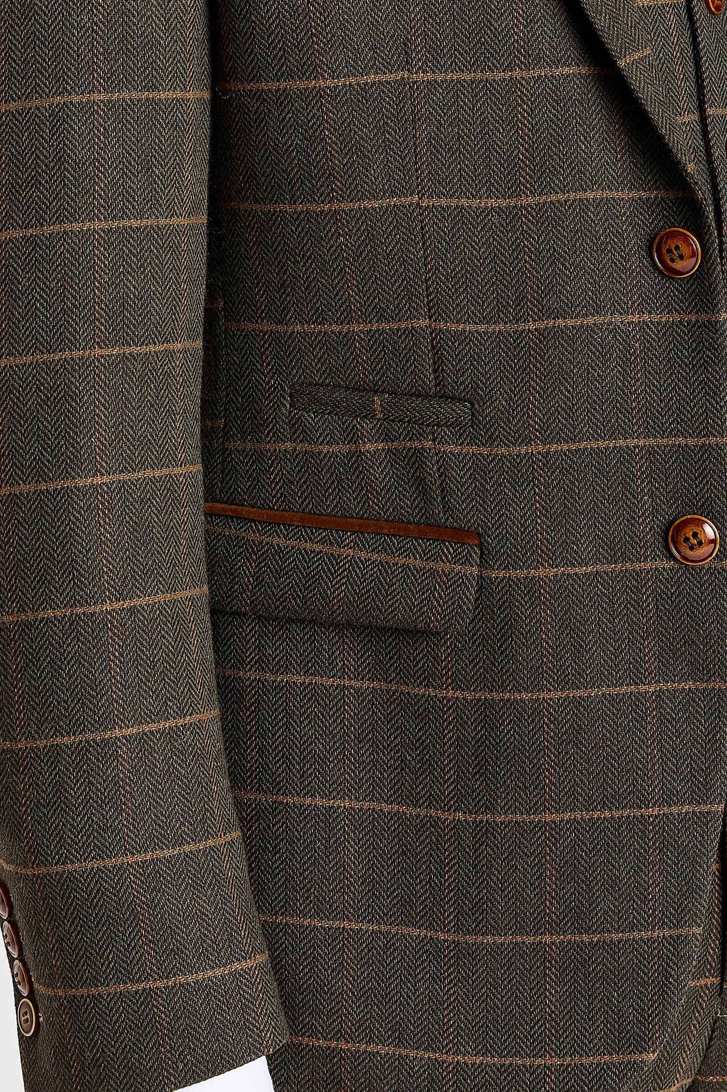 Close-up view of green herringbone tweed check blazer with buttons and front pockets showcasing the herringbone weave and orange check lines.
