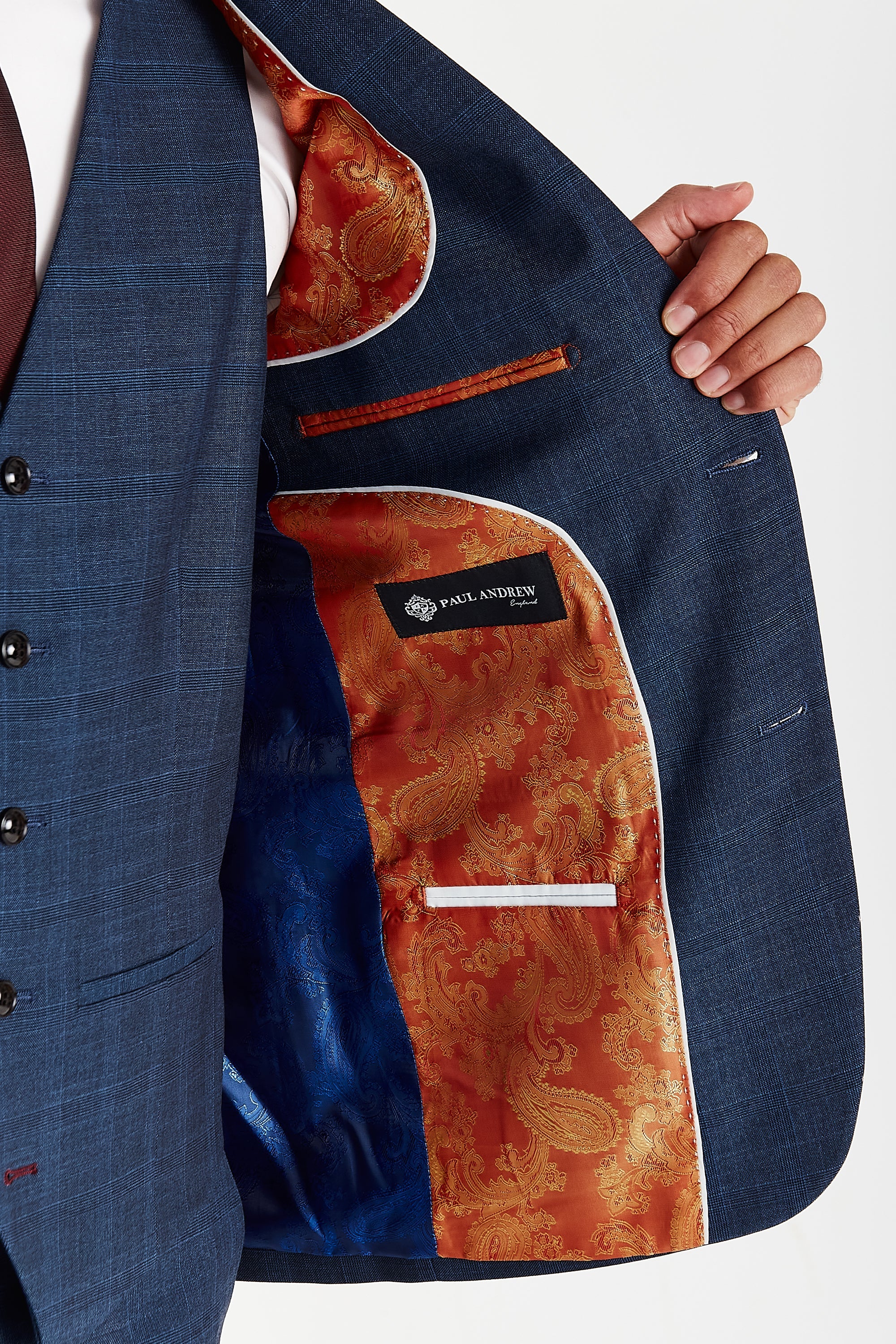 Interior view of the Viceroy navy check blazer with orange and blue paisley lining and a visible Paul Andrew logo label.