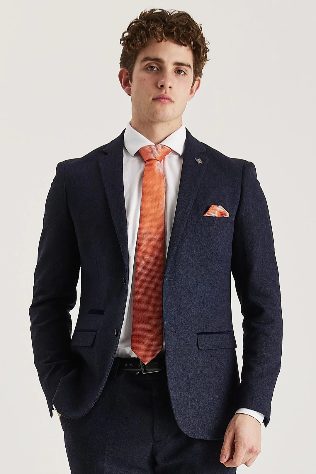 Front view of the navy tweed blazer, worn with matching trousers, a white shirt, orange tie and matching pocket square